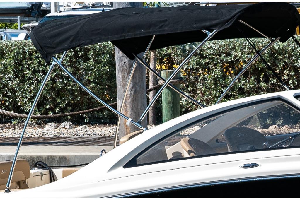 2023 Scout 240 Dorado boat with black canopy and sleek design.