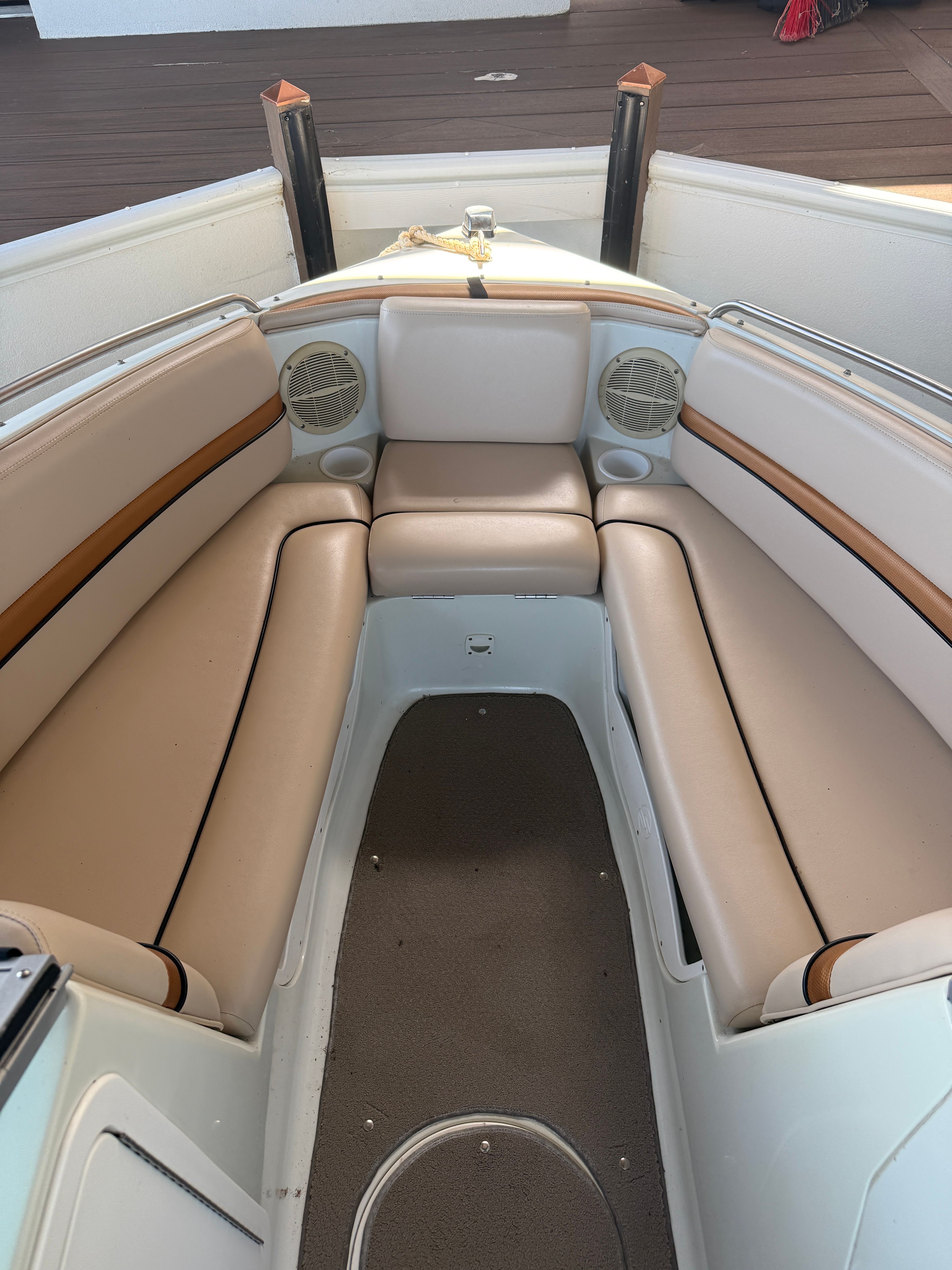 Interior view of a 2000 Starcraft Next Star 19 boat with beige upholstery.