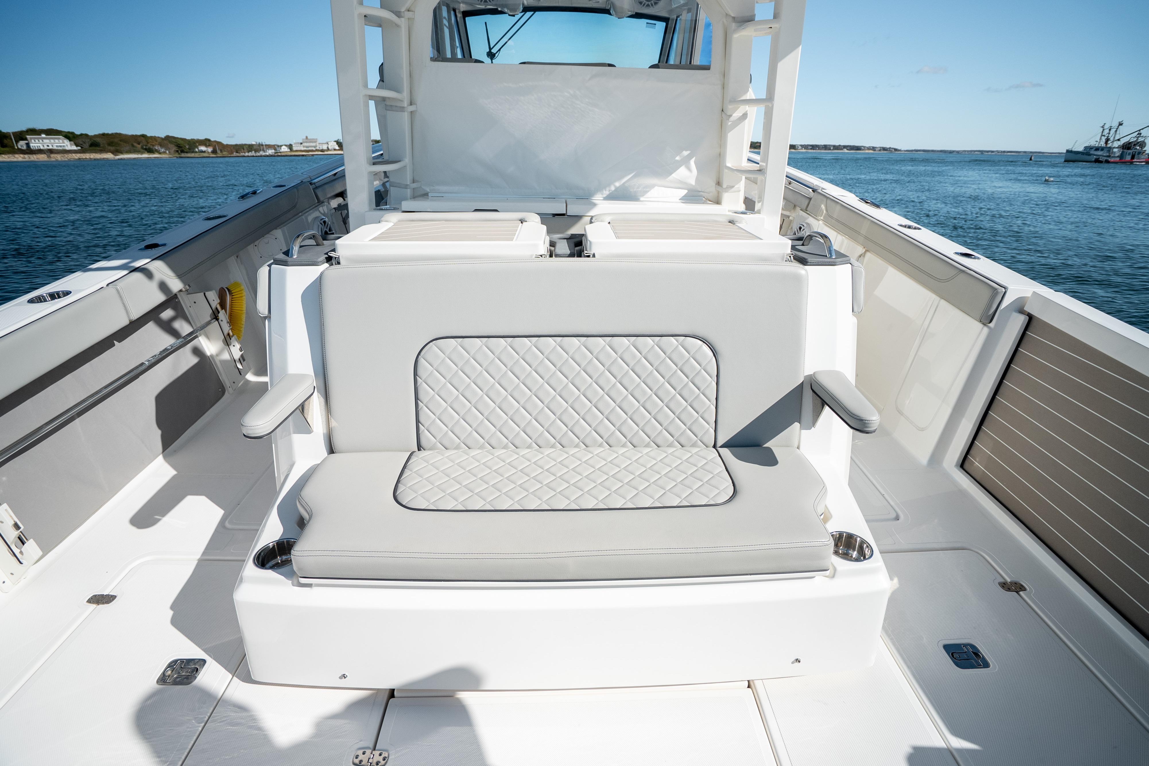 2023 Pursuit S 428 Sport boat interior with cushioned seating and ocean view.