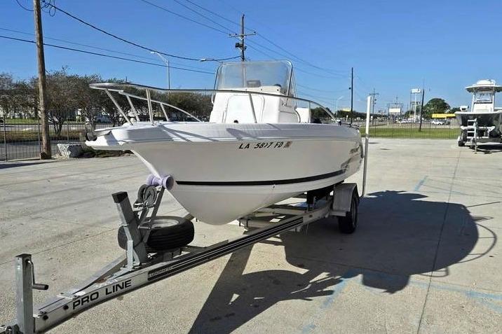 2001 Pro-Line 19 Sport boat on trailer in outdoor setting.