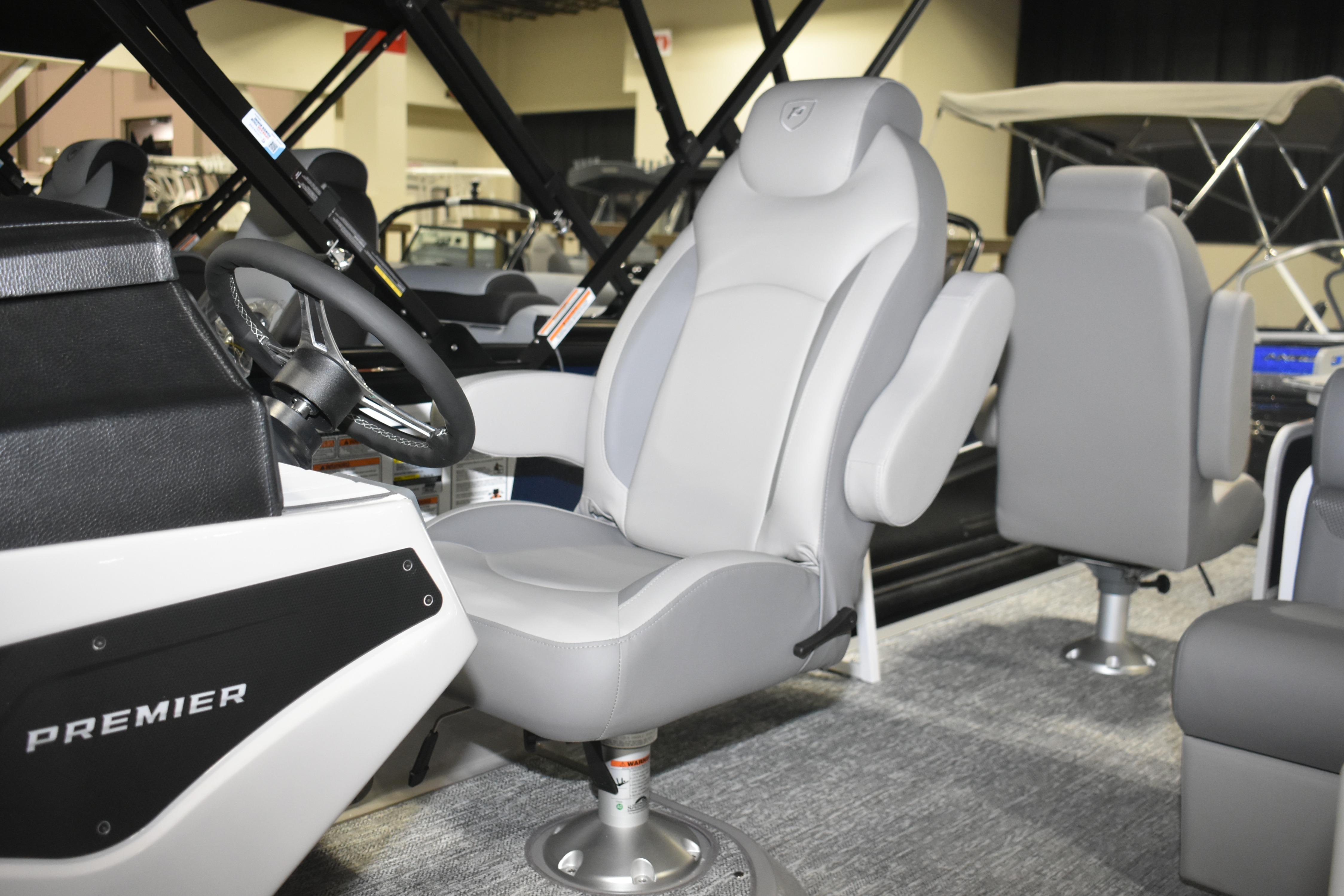 2026 Premier 230 Sunsation Angler 4PT boat interior with steering wheel and seating.
