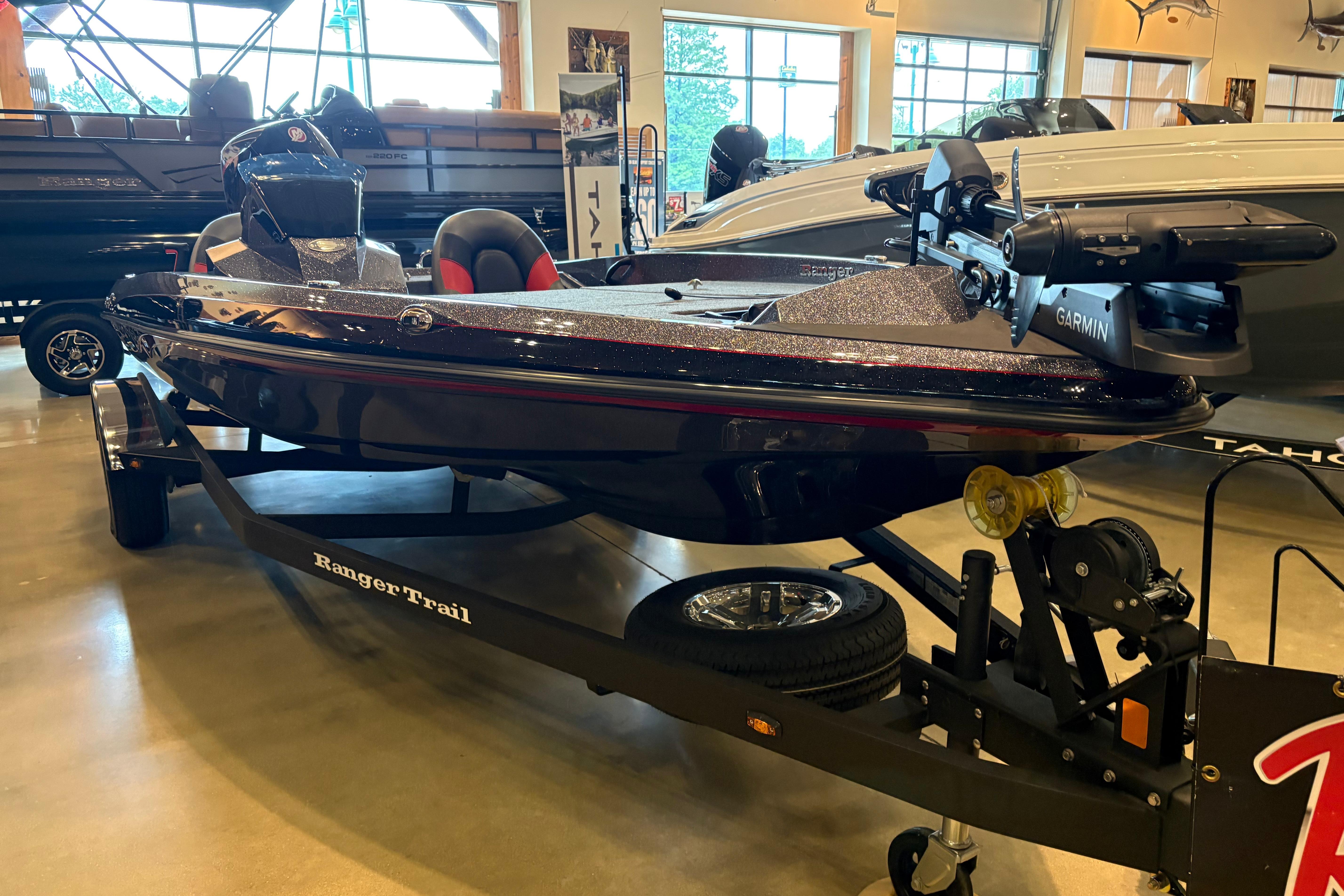 2025 Ranger Z185 boat on trailer in showroom, featuring Garmin equipment.