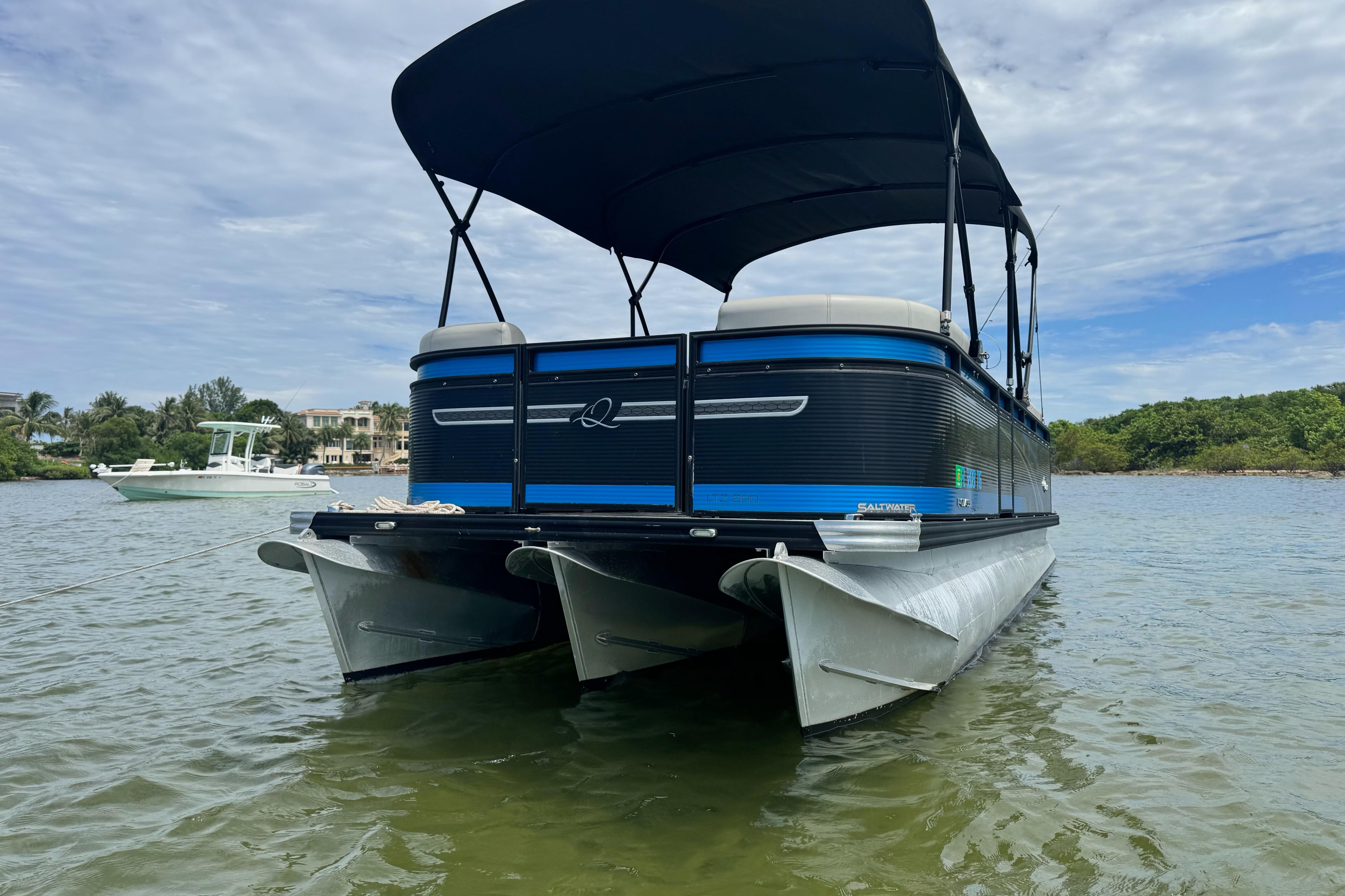 2022 Qwest Edge 820 CTR pontoon boat on calm water with canopy.