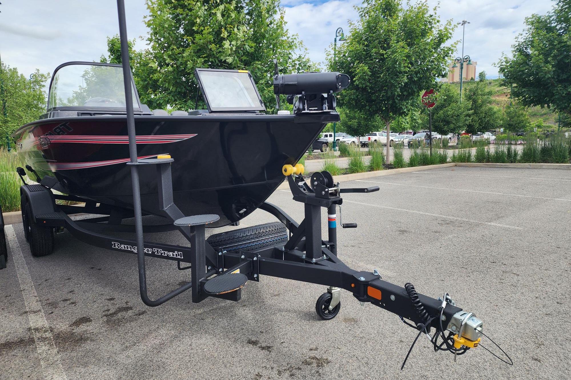 2026 Ranger VX1788 WT boat on trailer in parking lot, surrounded by trees.
