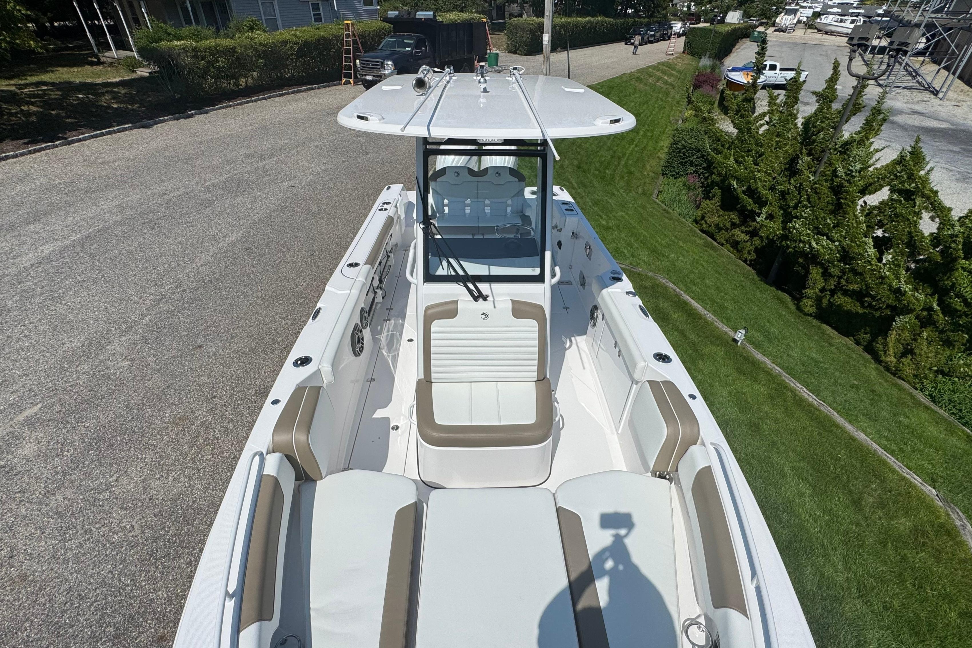 2026 Edgewater 250CC boat with spacious seating and sleek design, parked on a driveway.