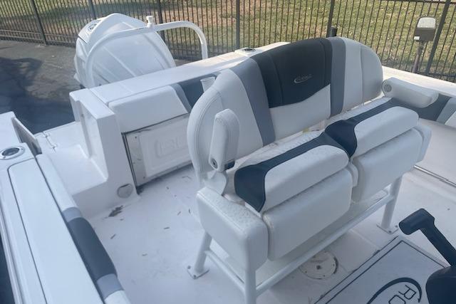2024 Robalo R230 Center Console boat interior with cushioned seating and storage.