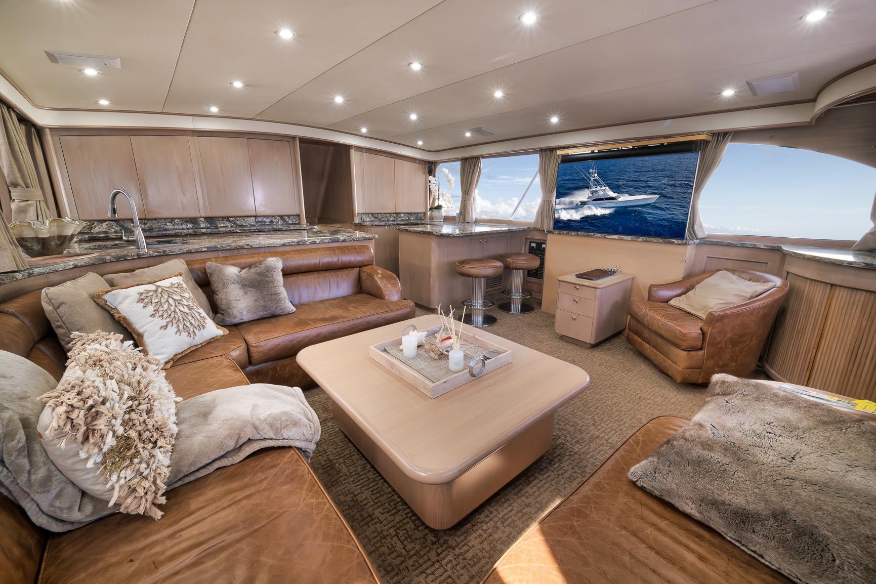 Luxurious interior of a 1993 Merritt Sportfish yacht with plush seating and ocean view.