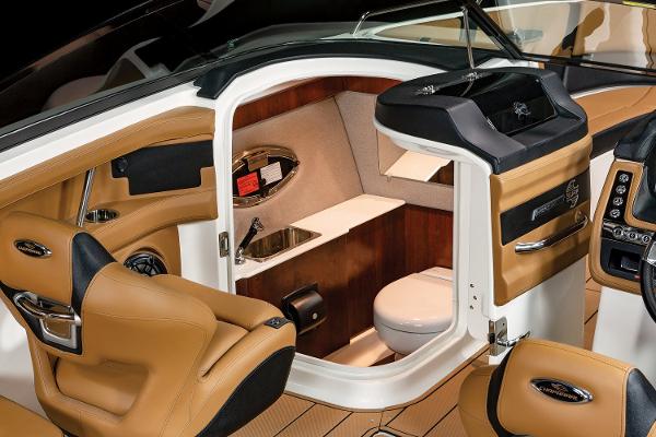Luxurious interior of 2024 Chaparral 28 Surf boat with tan leather seating.