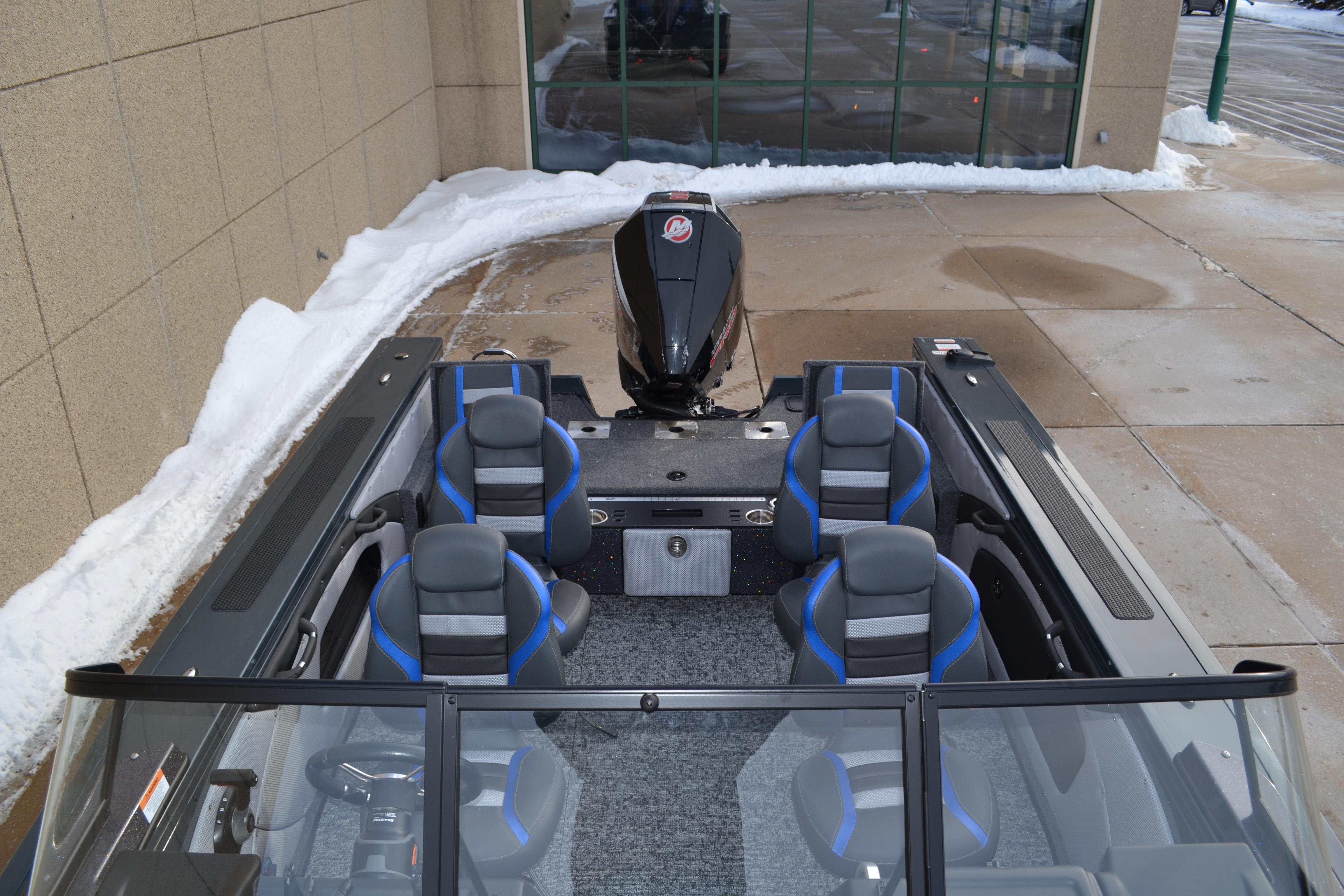 2026 Ranger VX1888 WT boat with blue-accented seats, parked on snowy pavement.