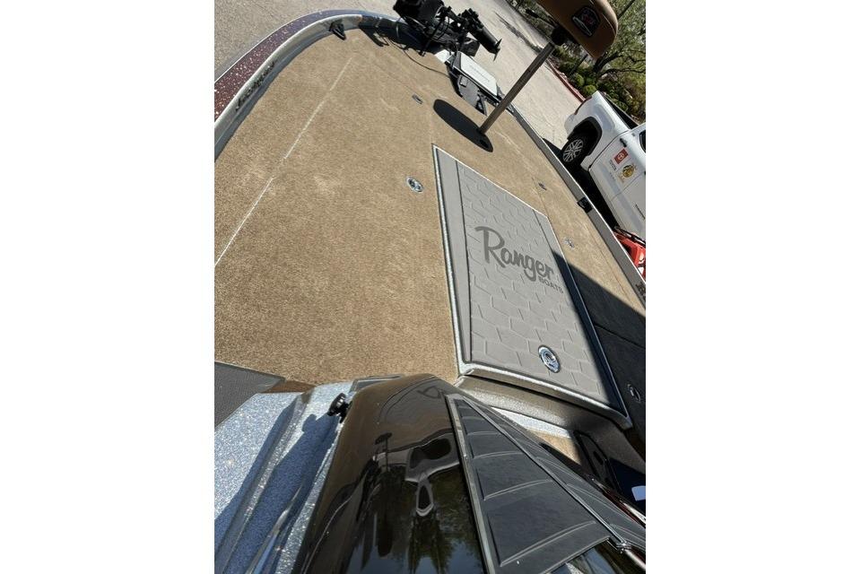 2026 Ranger Z521R Cup-Equipped boat deck with logo, parked near a white vehicle.