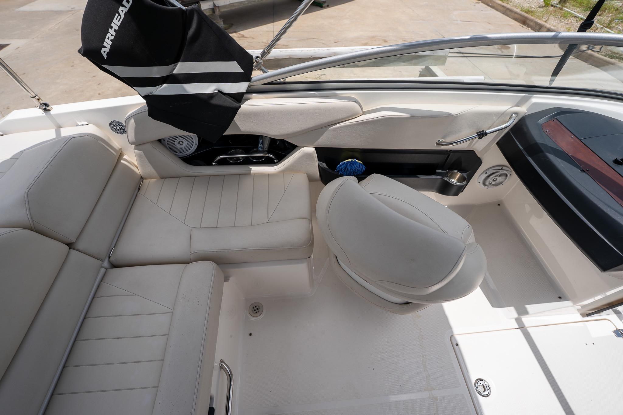 Interior of 2008 Regal 2000 Bowrider boat with white seating and steering area.