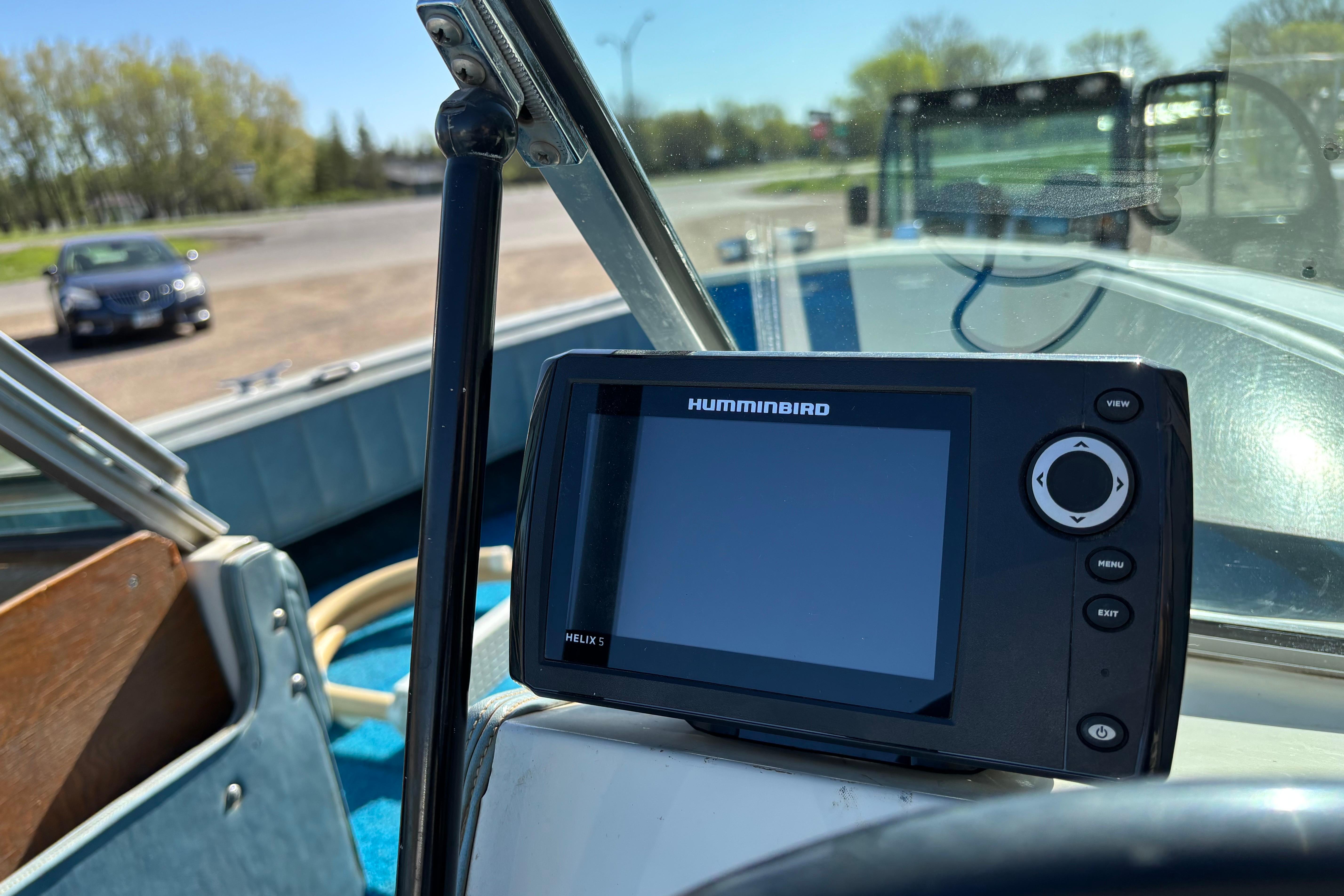 1983 Crestliner 16 boat interior with Humminbird Helix 5 fish finder on dashboard.