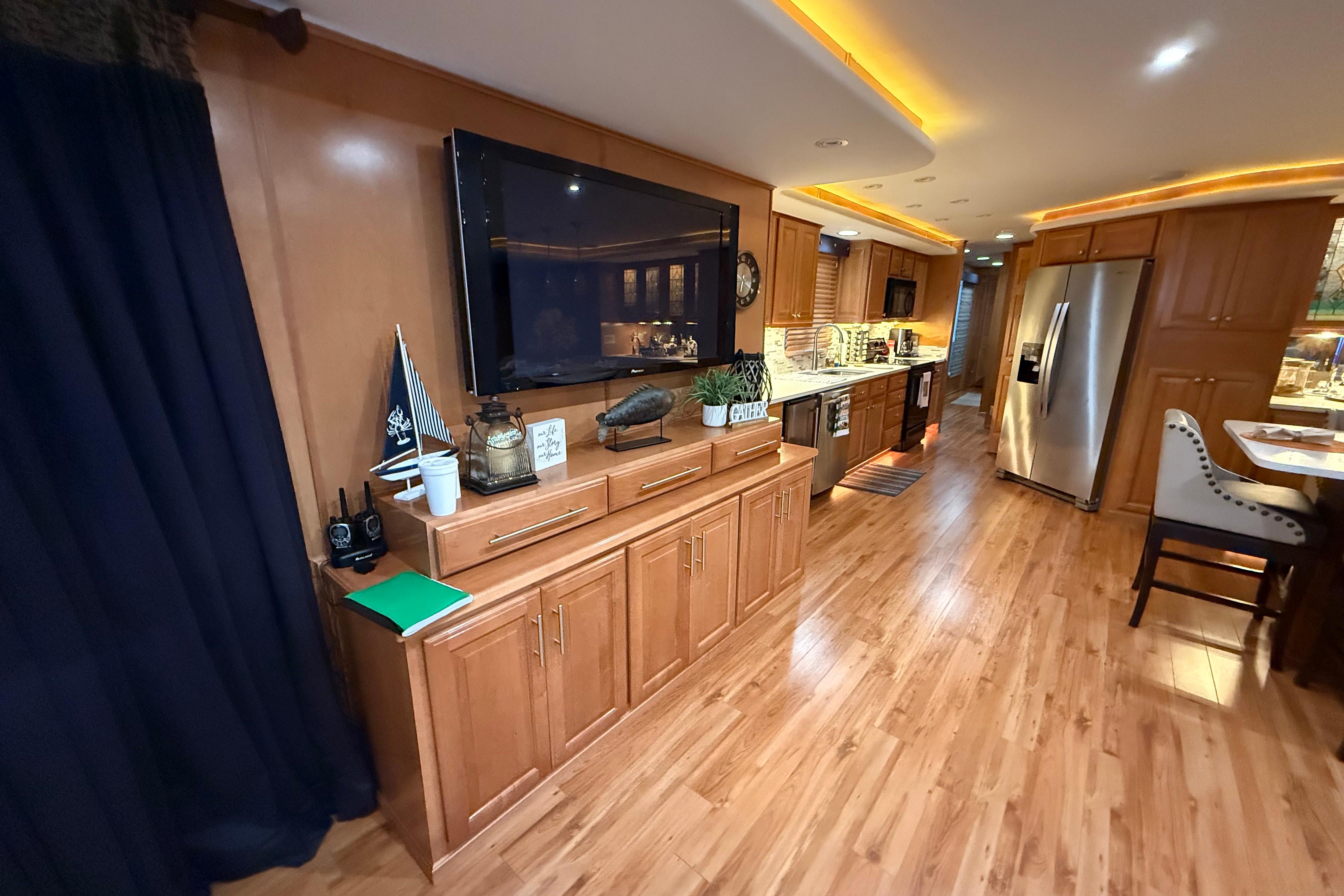 Luxurious interior of a 2001 Sharpe 80 X 18 houseboat with modern kitchen and wooden flooring.