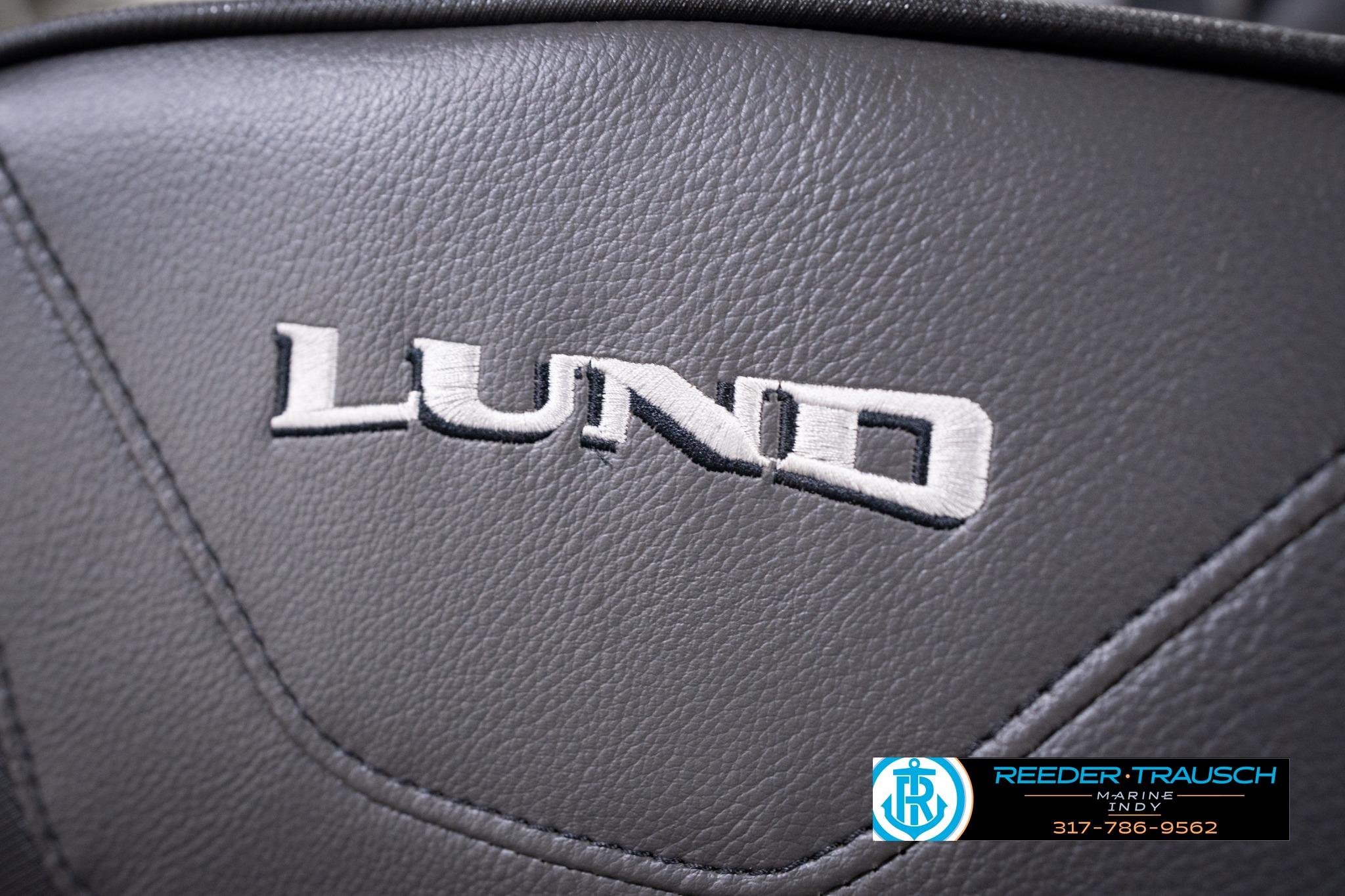 Close-up of 2026 Lund 1775 Impact XS SS logo on black leather surface.