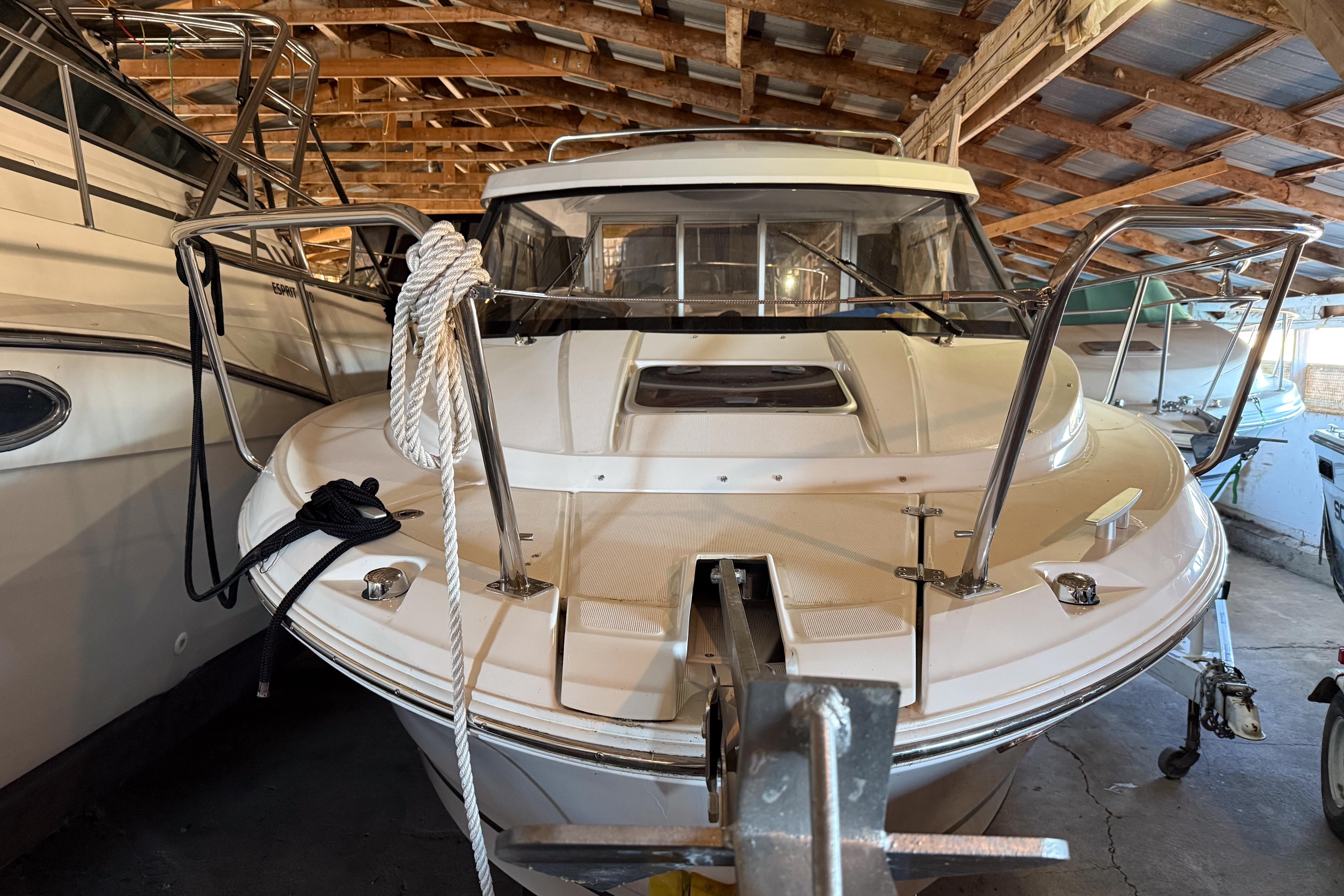 2022 Jeanneau NC 795 boat in storage, showcasing front deck and railing.