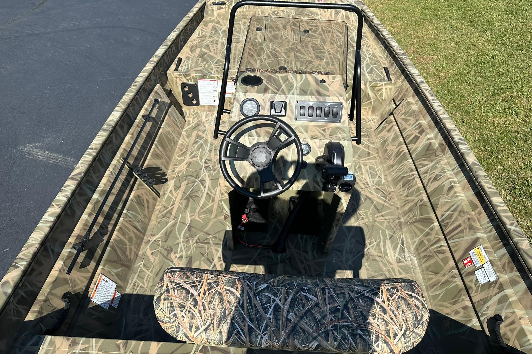 2026 Lowe Roughneck 2070CC boat with camouflage interior and steering console.