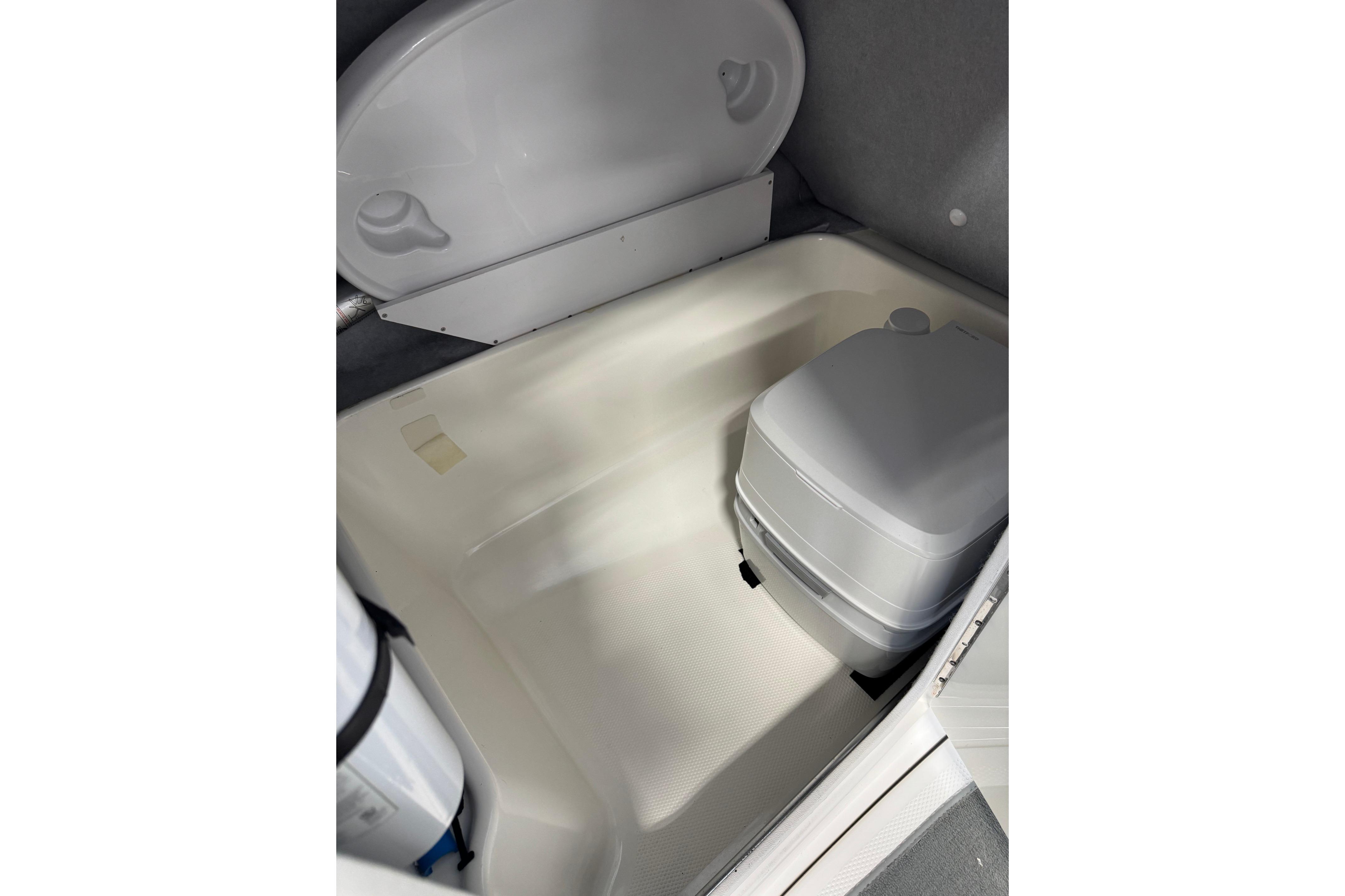 2007 Yamaha SX230 HO boat interior with portable toilet and storage area.