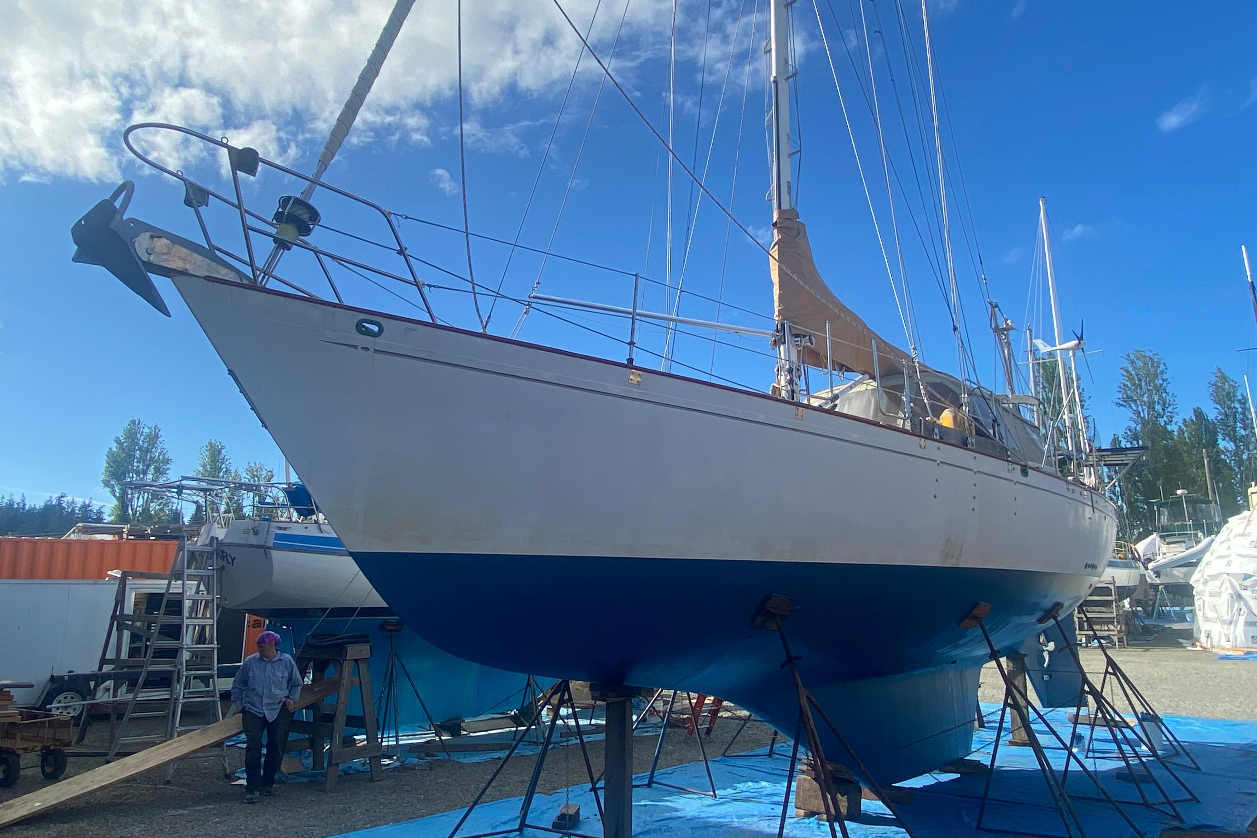 Sailboat Kelly Peterson 46, 1981 model, on dry dock under clear blue sky.
