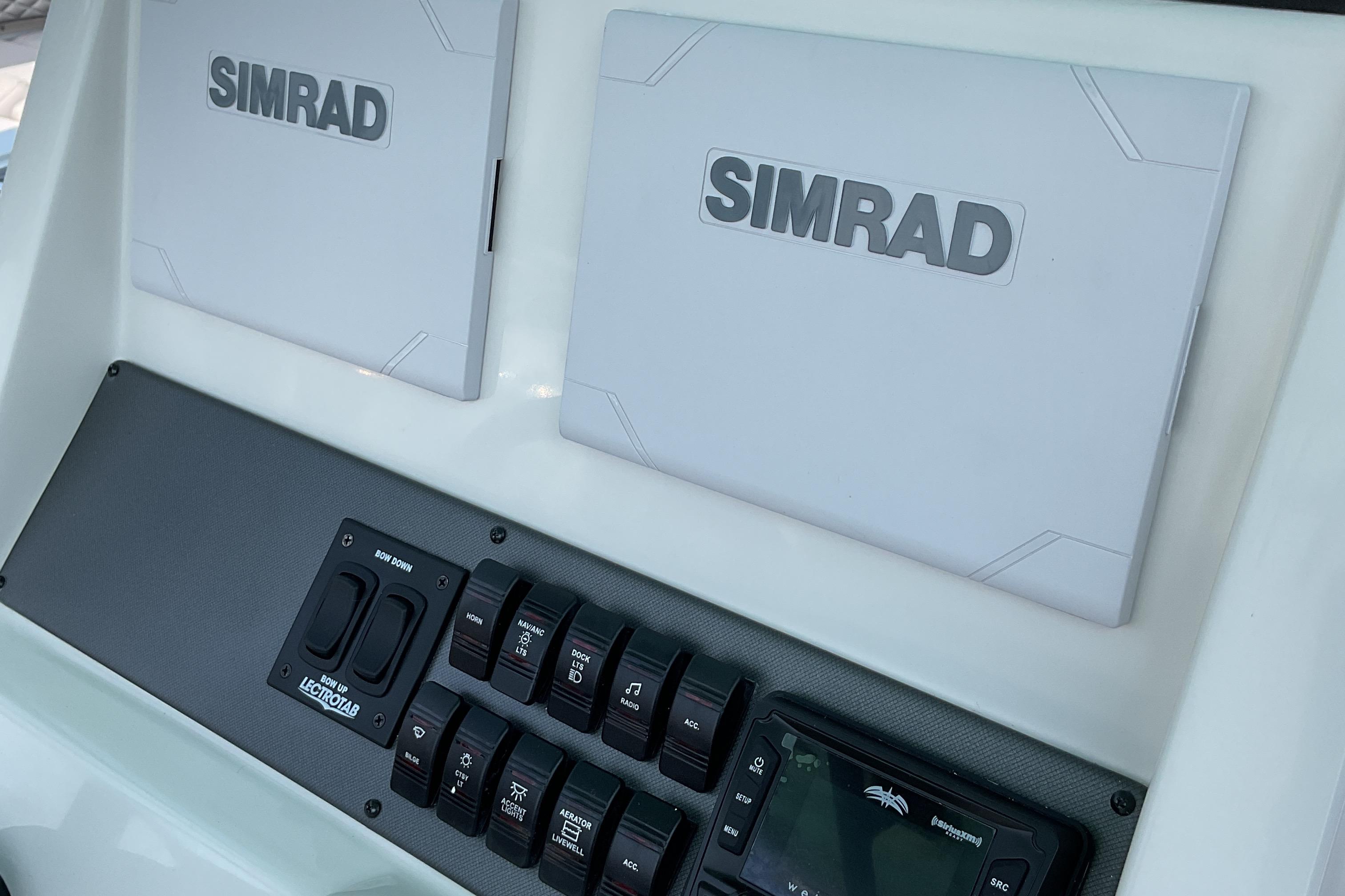 2026 Starcraft SVX 231 OB CC dashboard with Simrad displays and control panel.