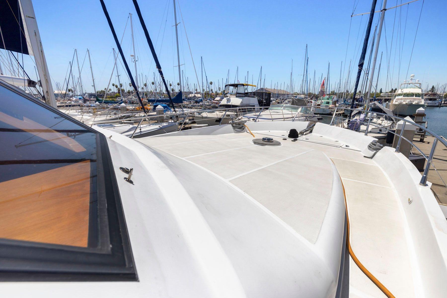 Bow view of a 1999 Symbol 55 yacht docked in a marina.