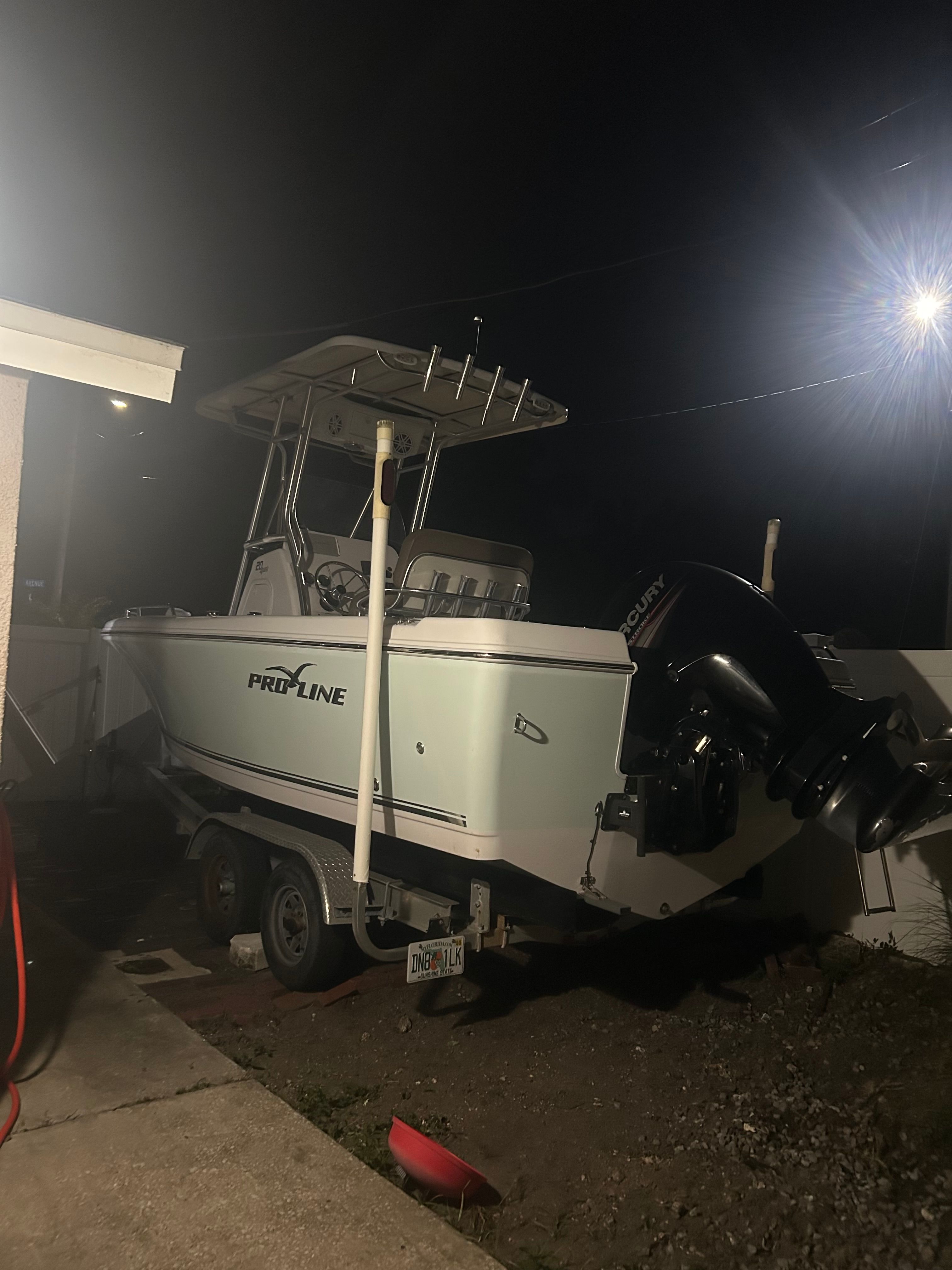 2017 Pro-Line 20 Sport boat on trailer at night.