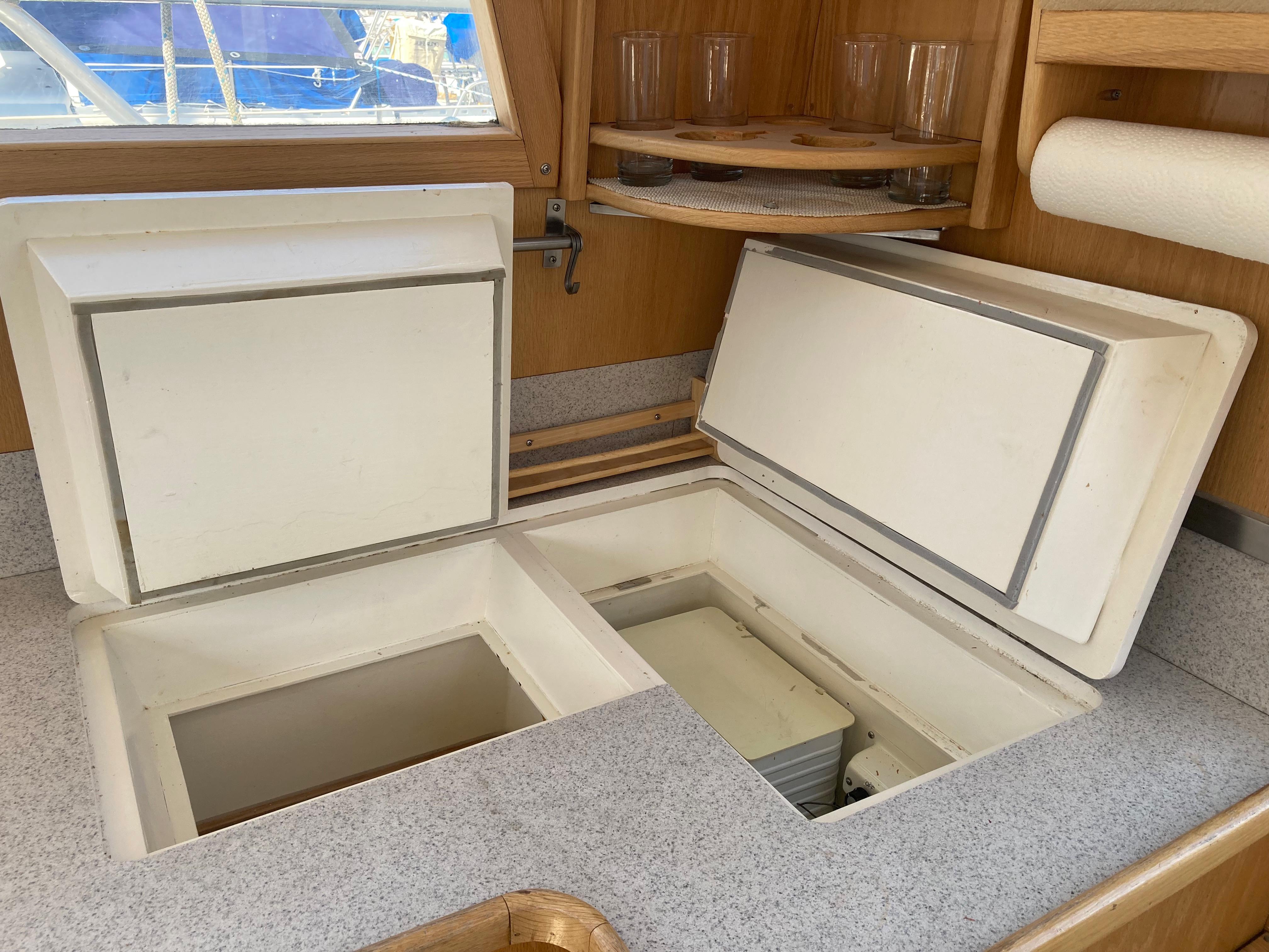 Interior of 1991 Bruce Roberts Pilothouse sloop, featuring open storage compartments in the galley.