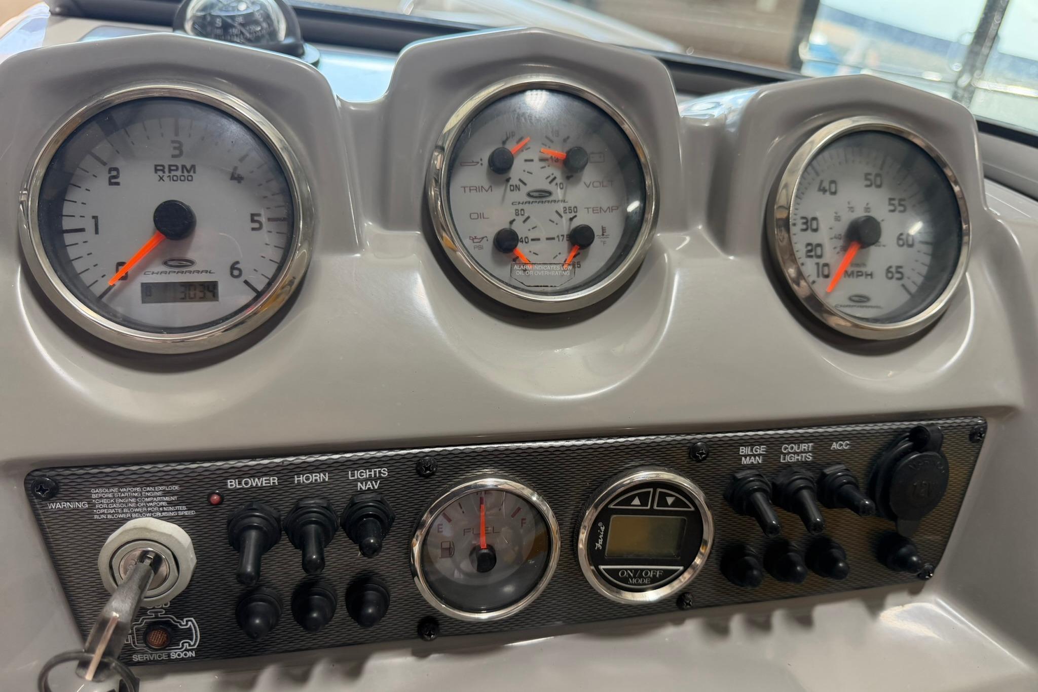 Dashboard of a 2012 Chaparral 19 Sport H2O boat with gauges and controls.