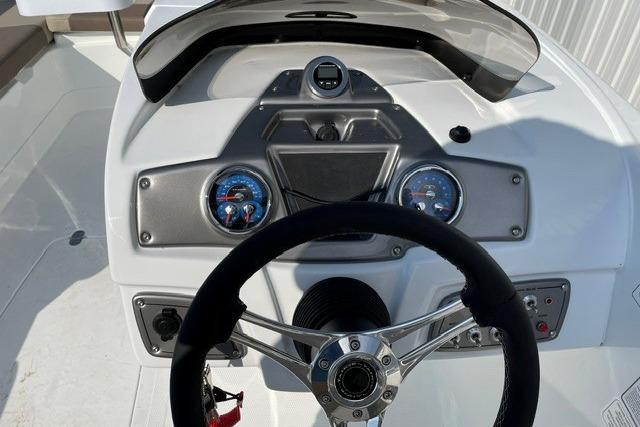 2026 Tahoe 2150 boat dashboard with steering wheel and gauges in a sleek design.