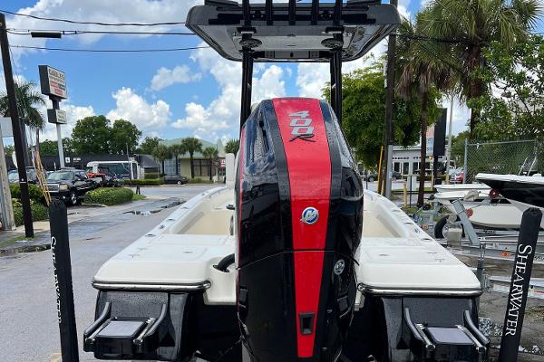 2024 ShearWater 260 Carolina Flare boat with powerful outboard motor, parked outdoors.