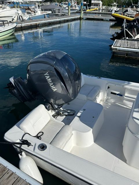A 2001 Edgewater 185CC boat is docked. It features a Yamaha outboard motor.