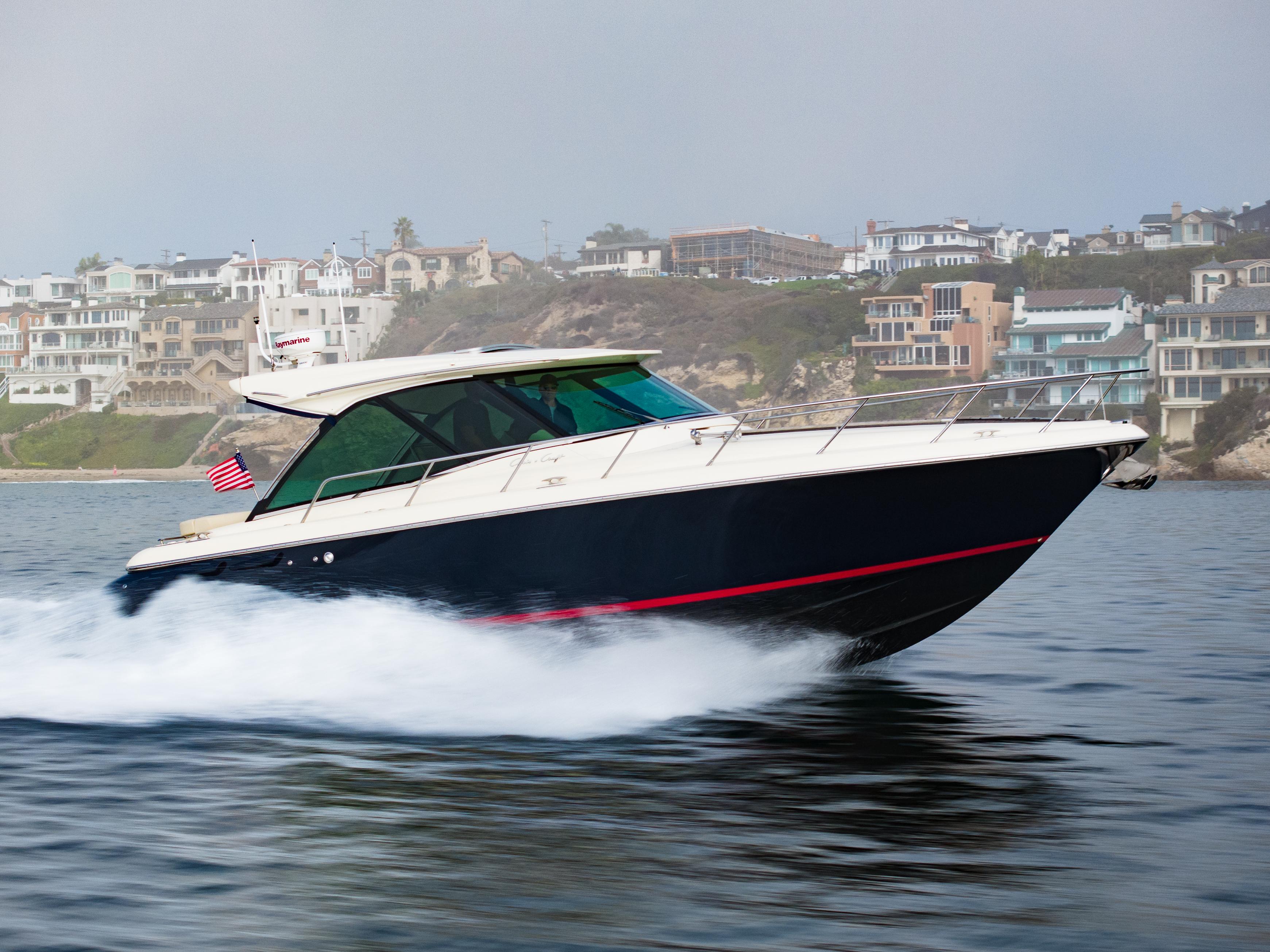2014 Chris-Craft Corsair 36 Hard Top cruising on water near coastal homes.