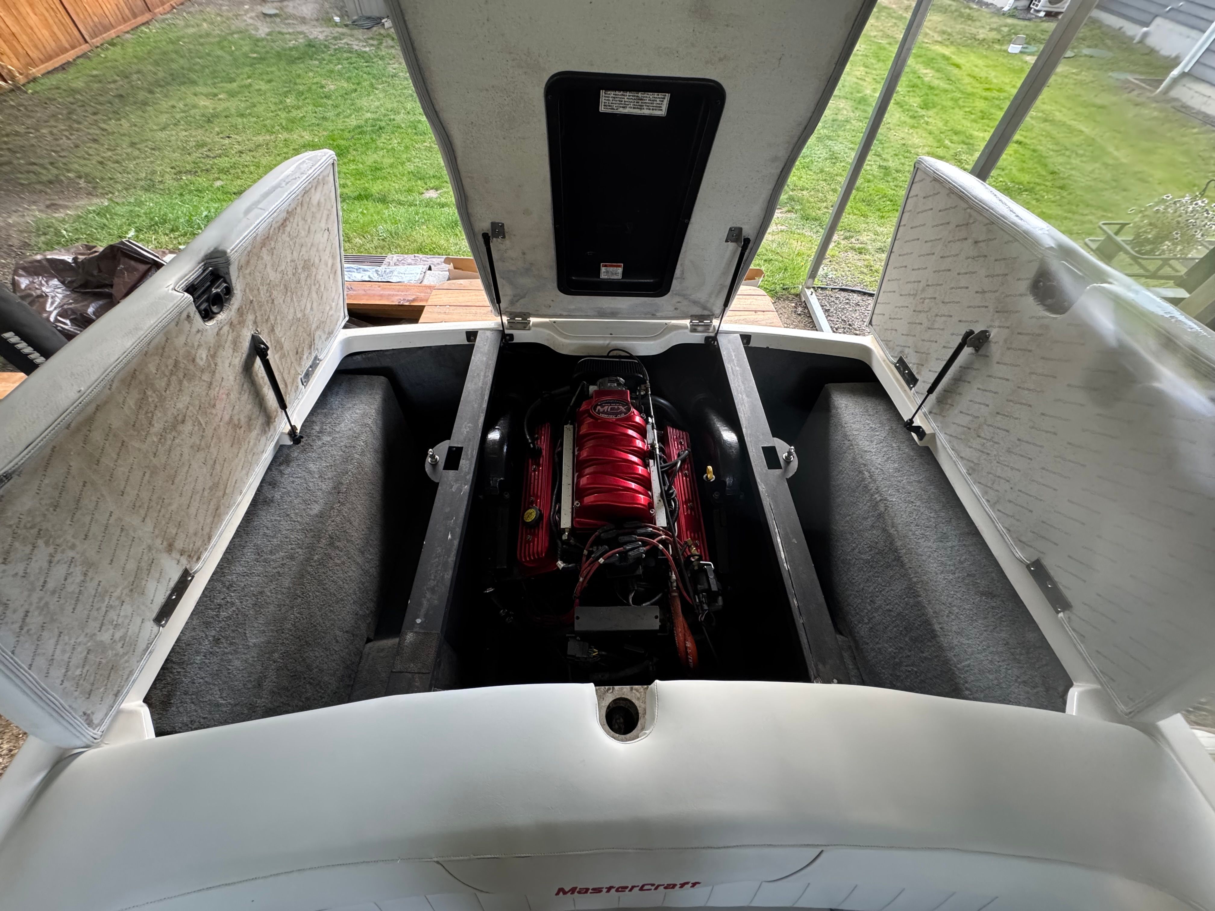The engine compartment of a 2003 MasterCraft X2 with a red engine block.