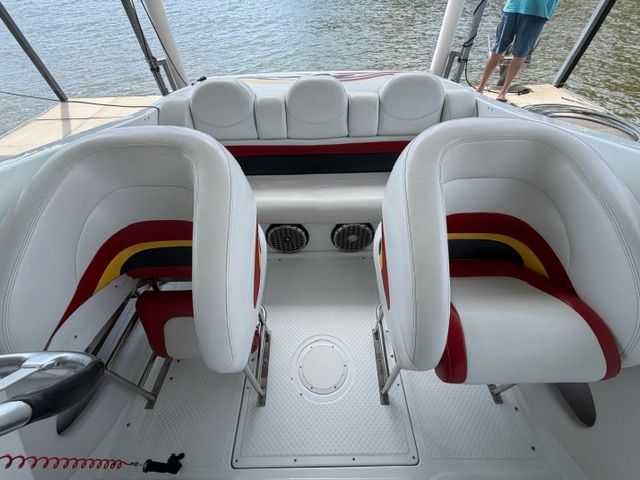 Interior of a 2002 Baja 25 Outlaw with white and red seating.