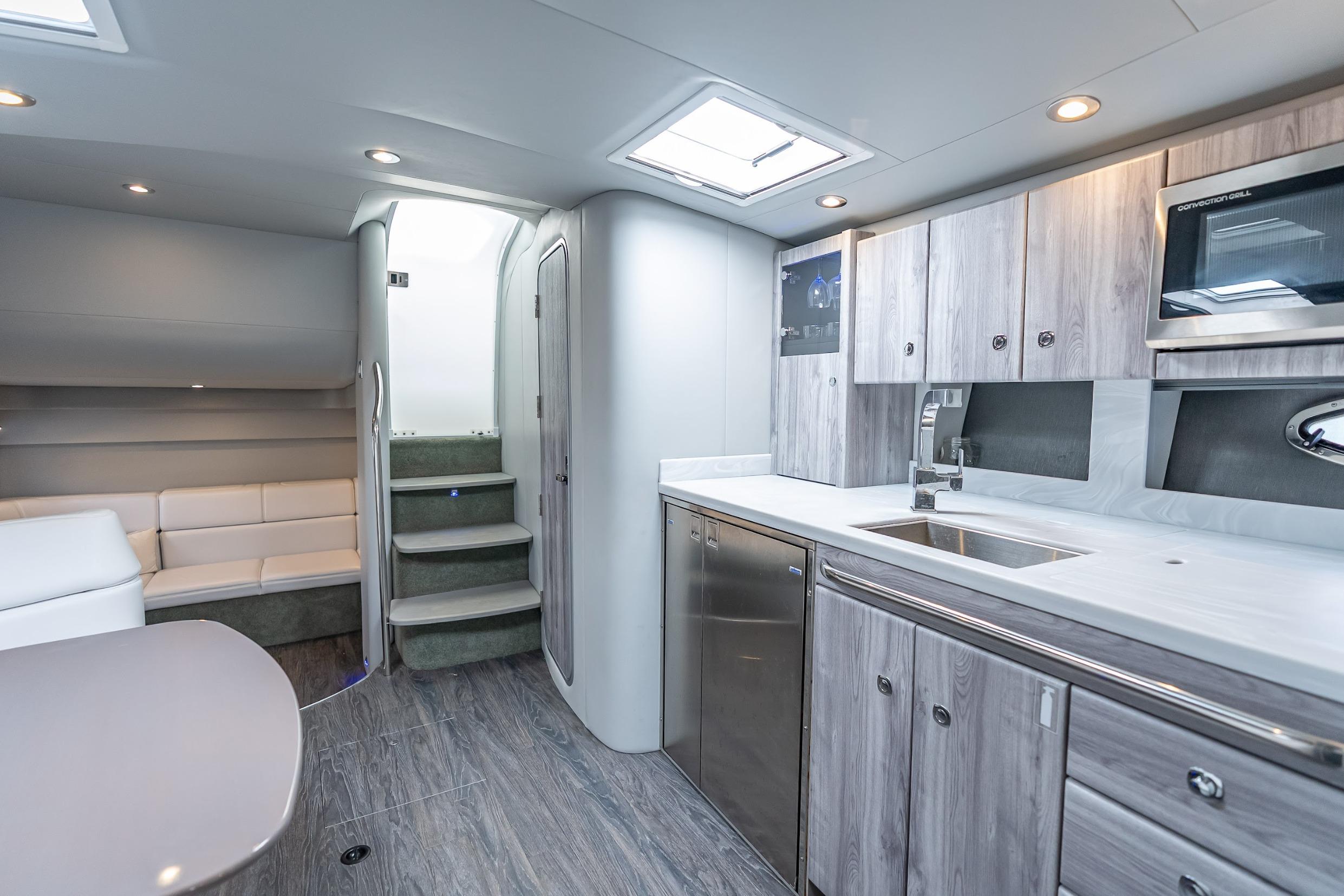 Luxurious interior of 2022 Formula 40 Performance Cruiser with modern kitchen and seating area.
