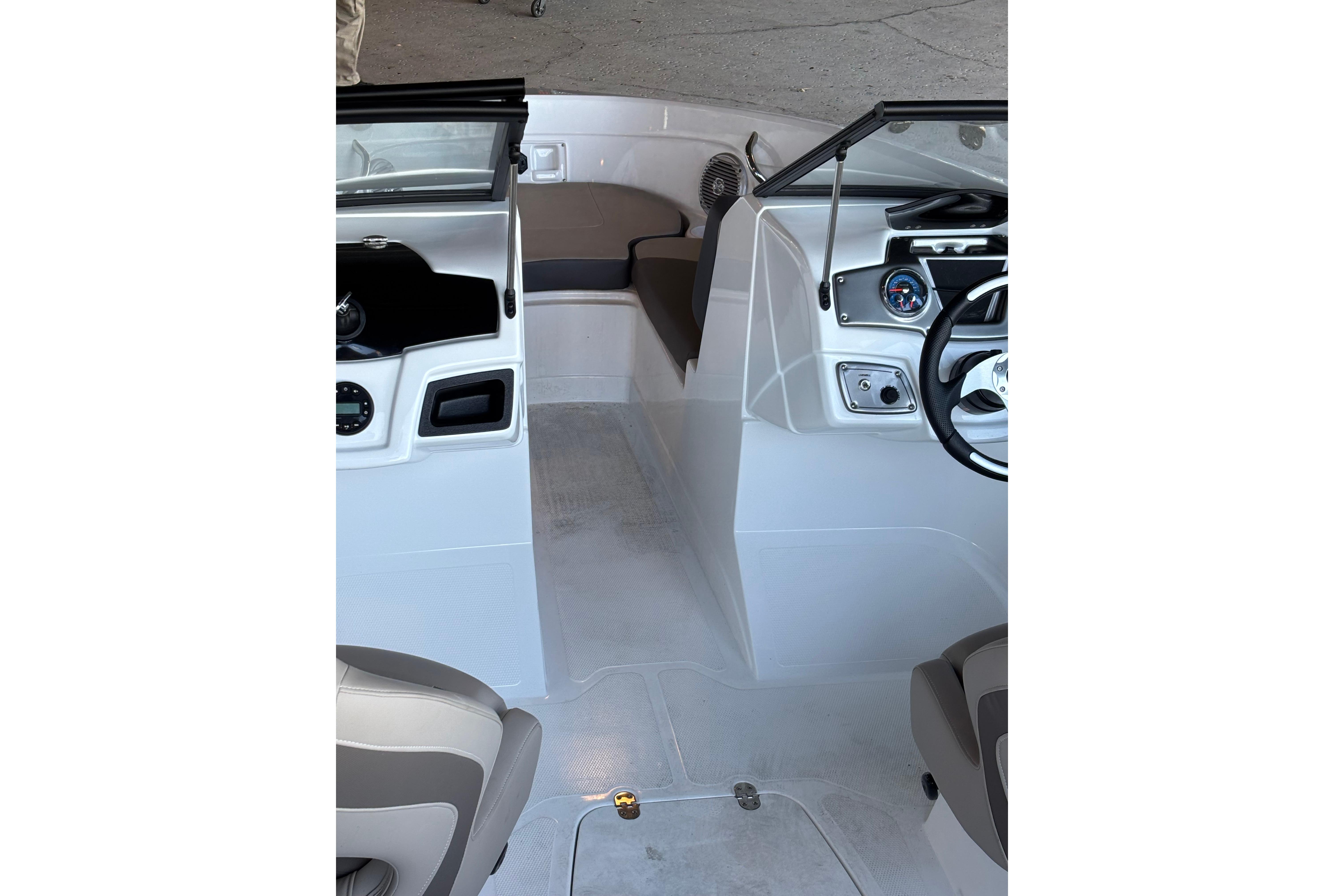 Interior view of 2025 Tahoe 200 S boat, featuring steering wheel and seating area.