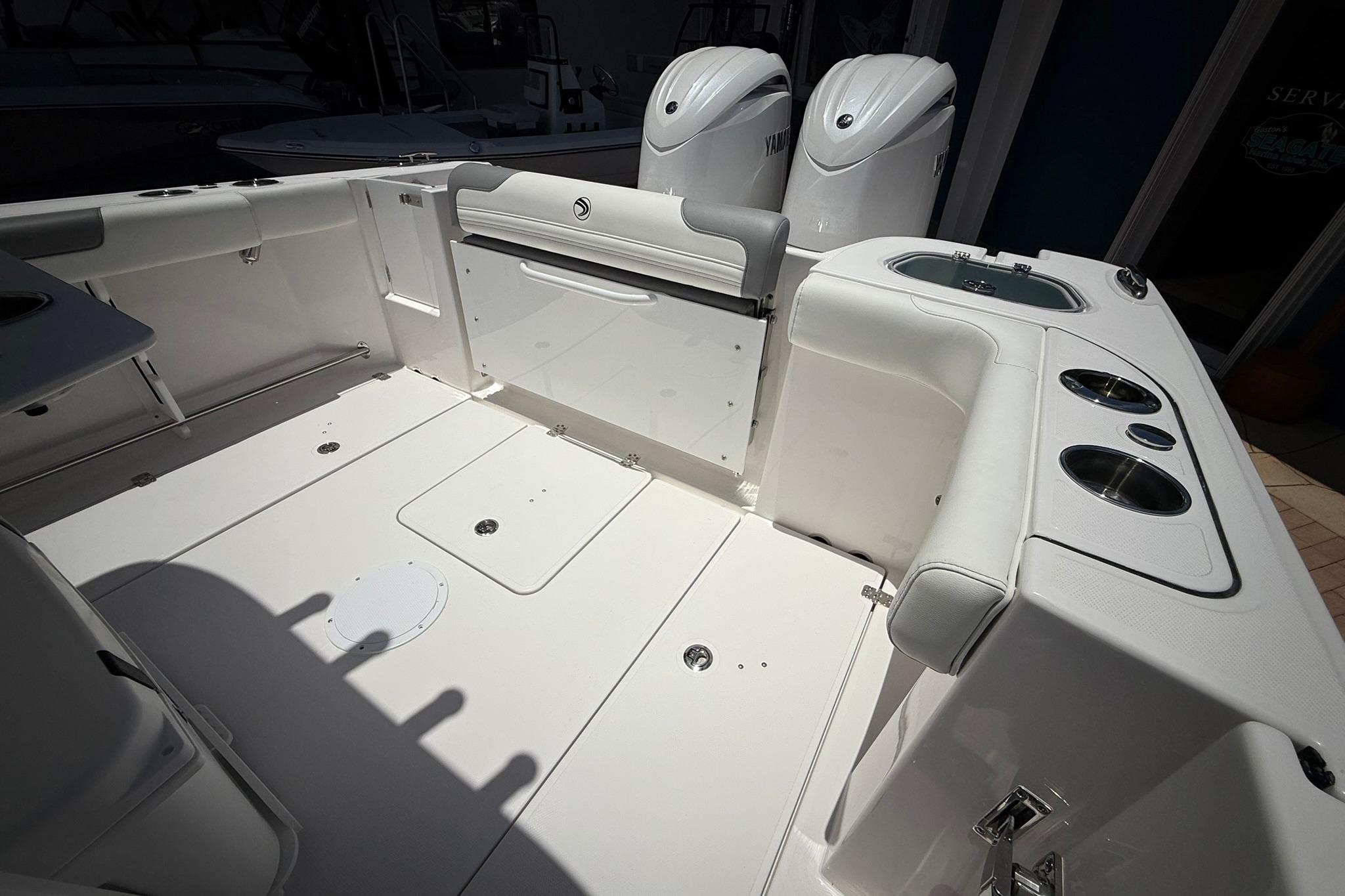 2026 Edgewater 250CC boat interior with dual engines and sleek white seating.