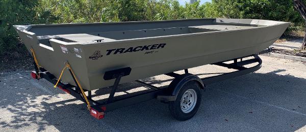 2025 Tracker GRIZZLY 2072 Utility boat on trailer, parked outdoors.