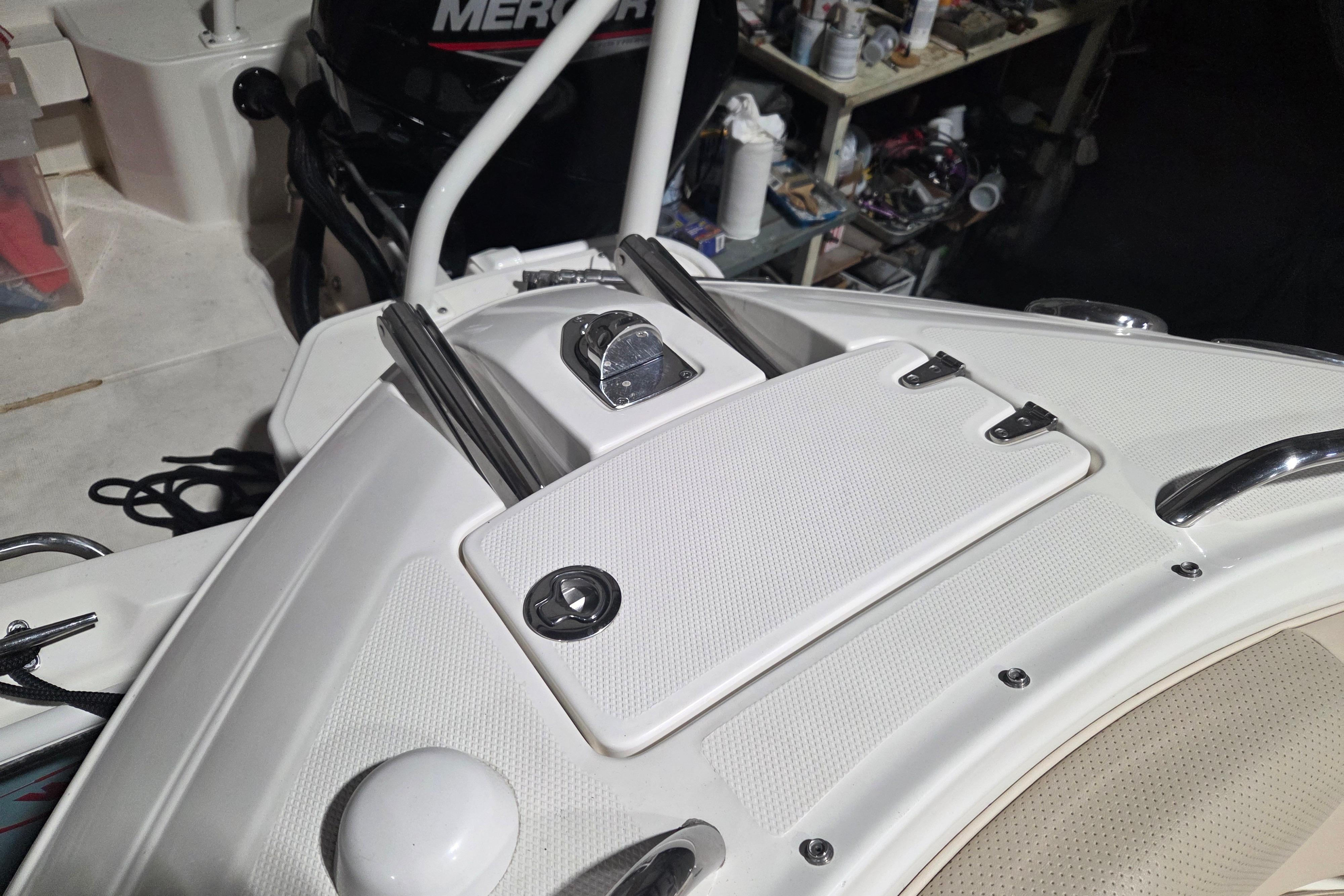 2006 Chaparral 236 SSi boat deck with storage compartment and Mercury engine.