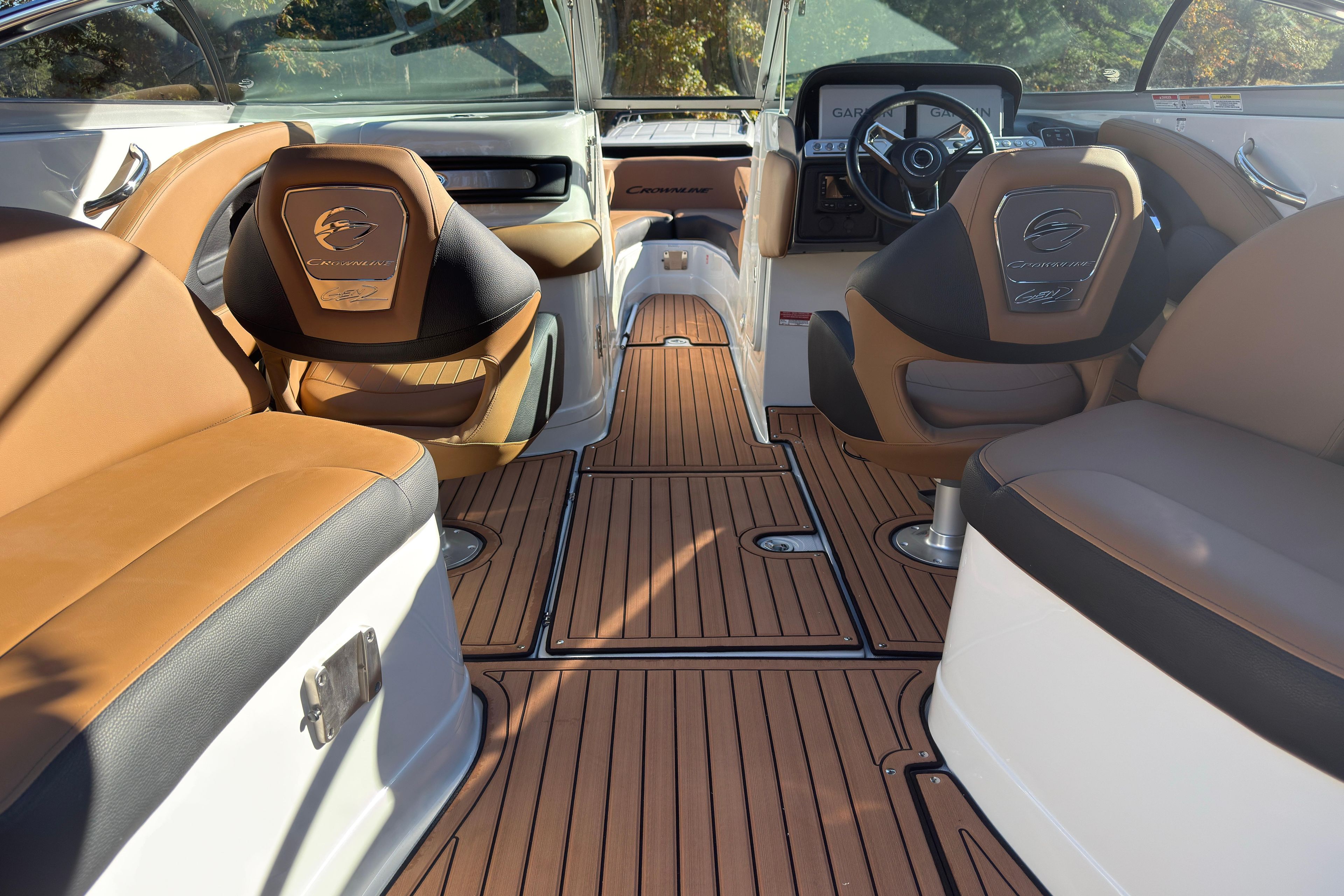 Luxurious interior of 2026 Crownline 298 SS boat with elegant seating and wood flooring.