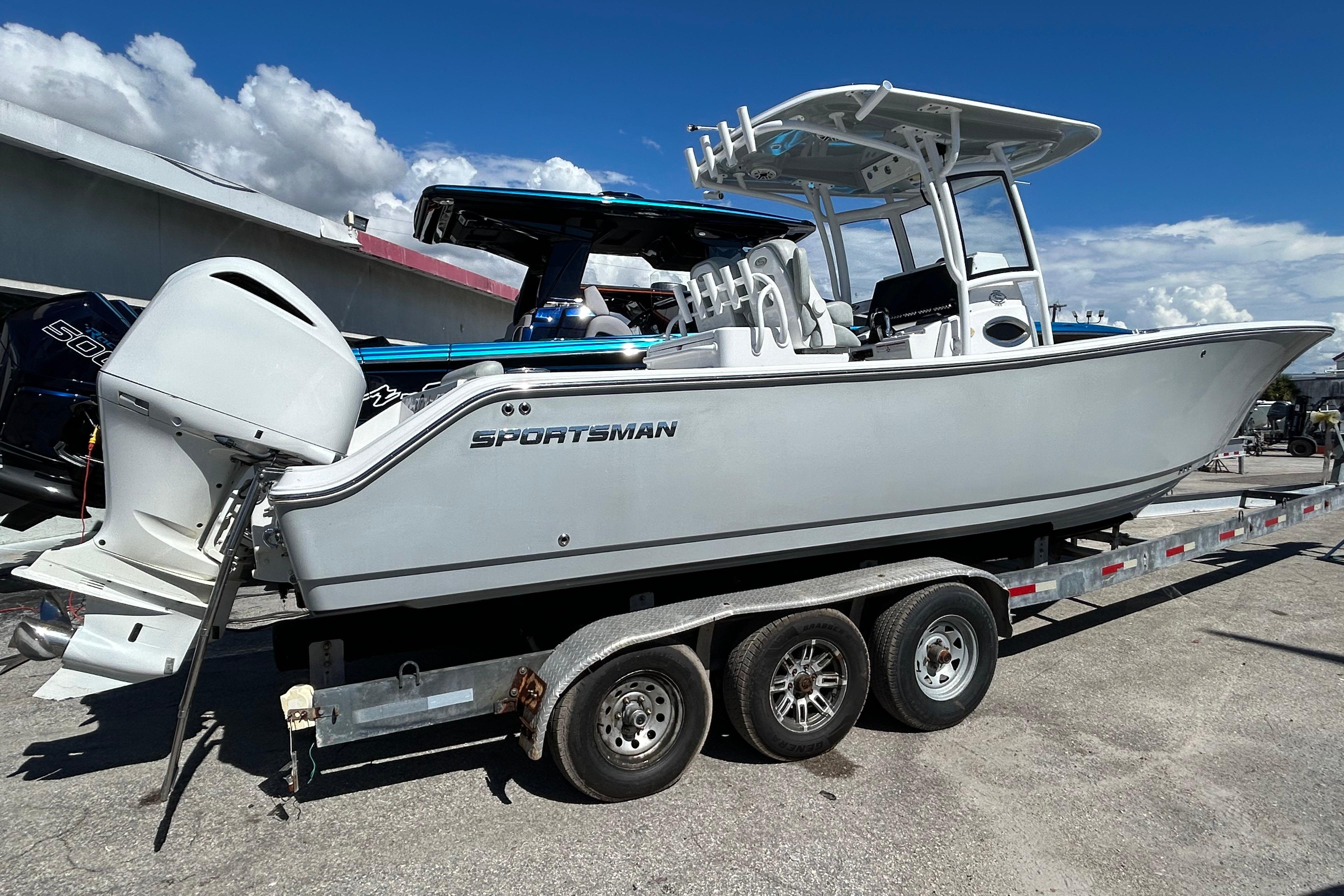 2019 Sportsman Open 282 Center Console boat on a trailer, under a clear blue sky.