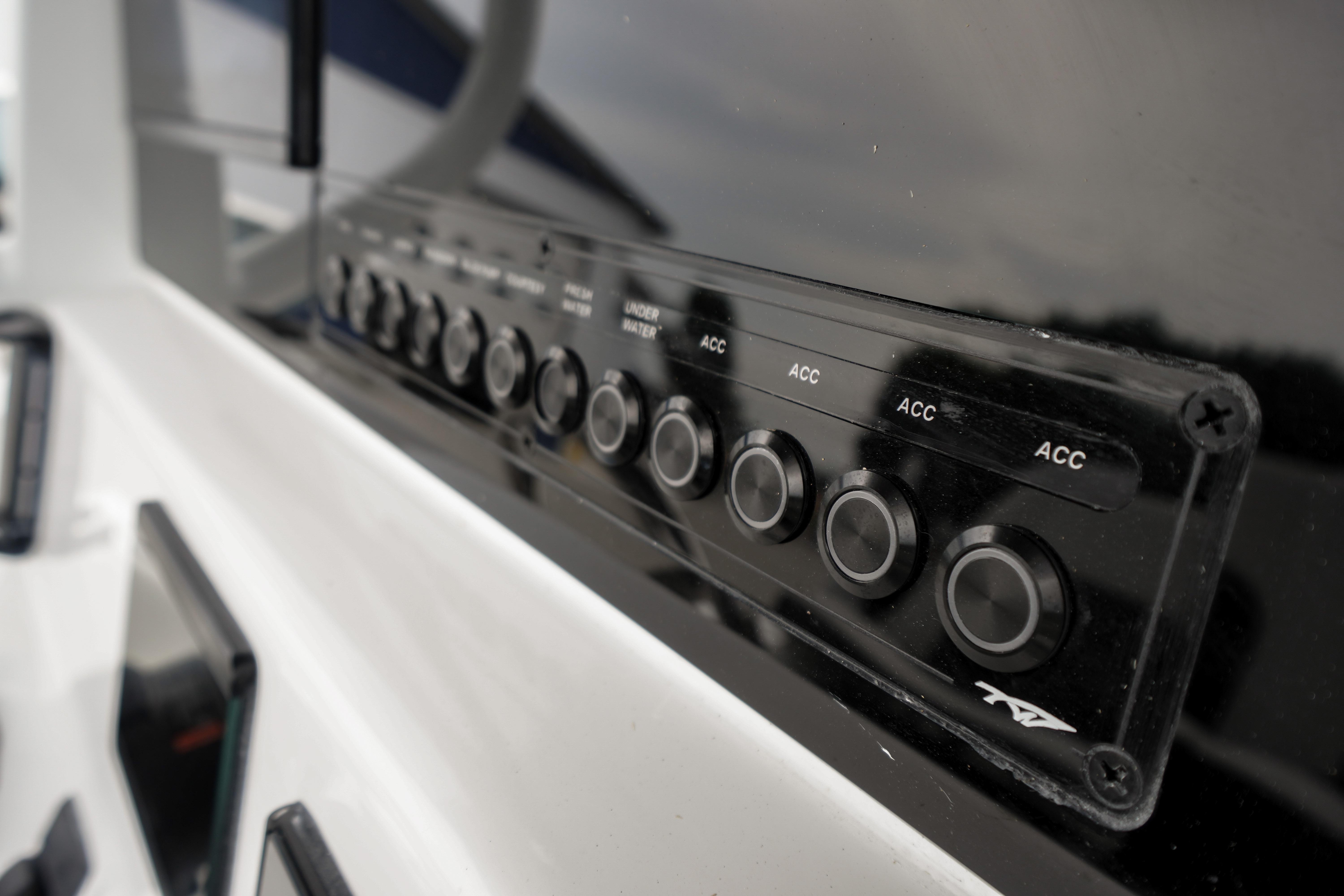 Control panel of 2026 Tidewater 232 SS boat with multiple buttons and switches.