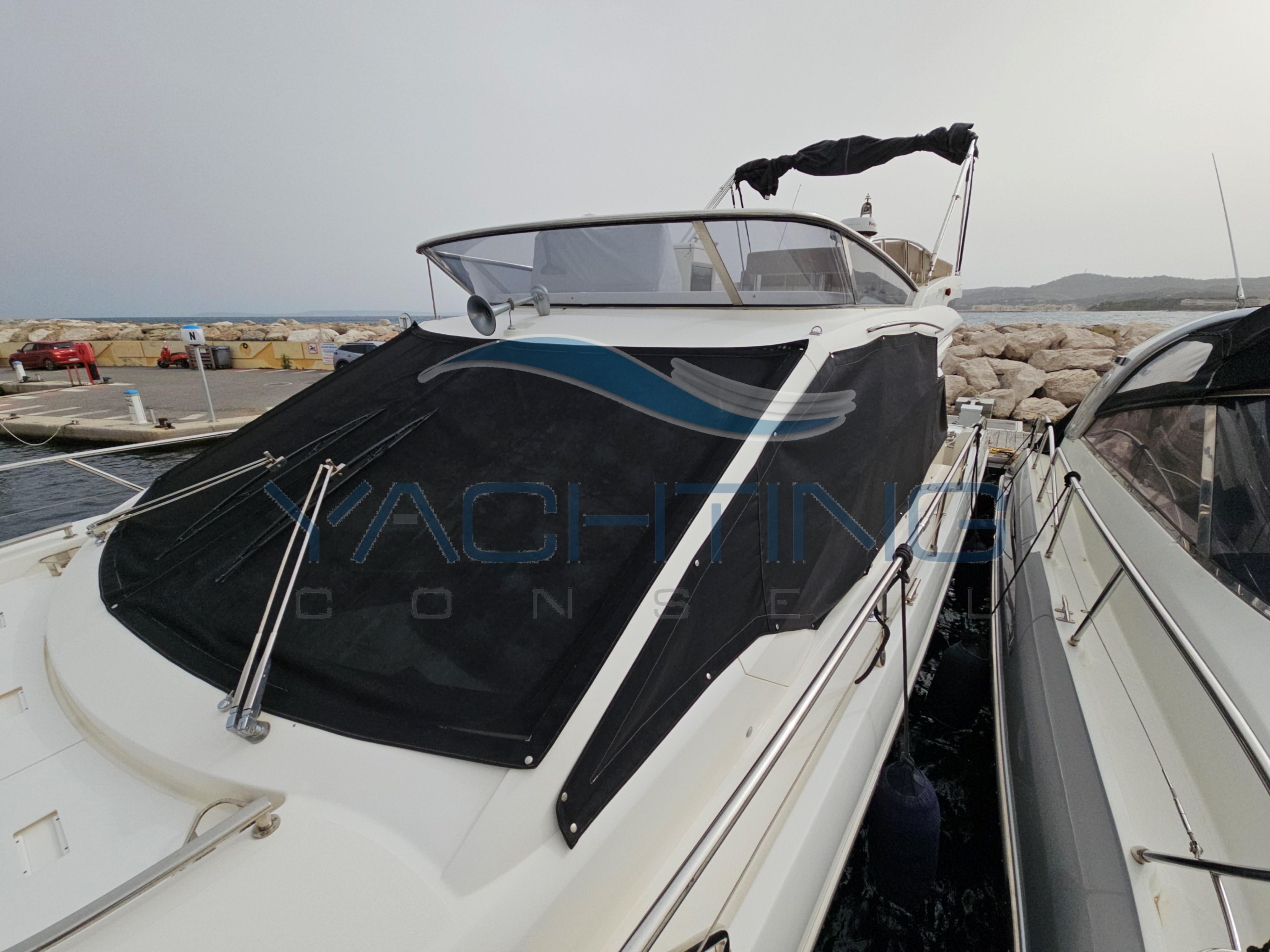 2018 Absolute 45 FLY yacht docked at marina, featuring sleek design and covered deck.