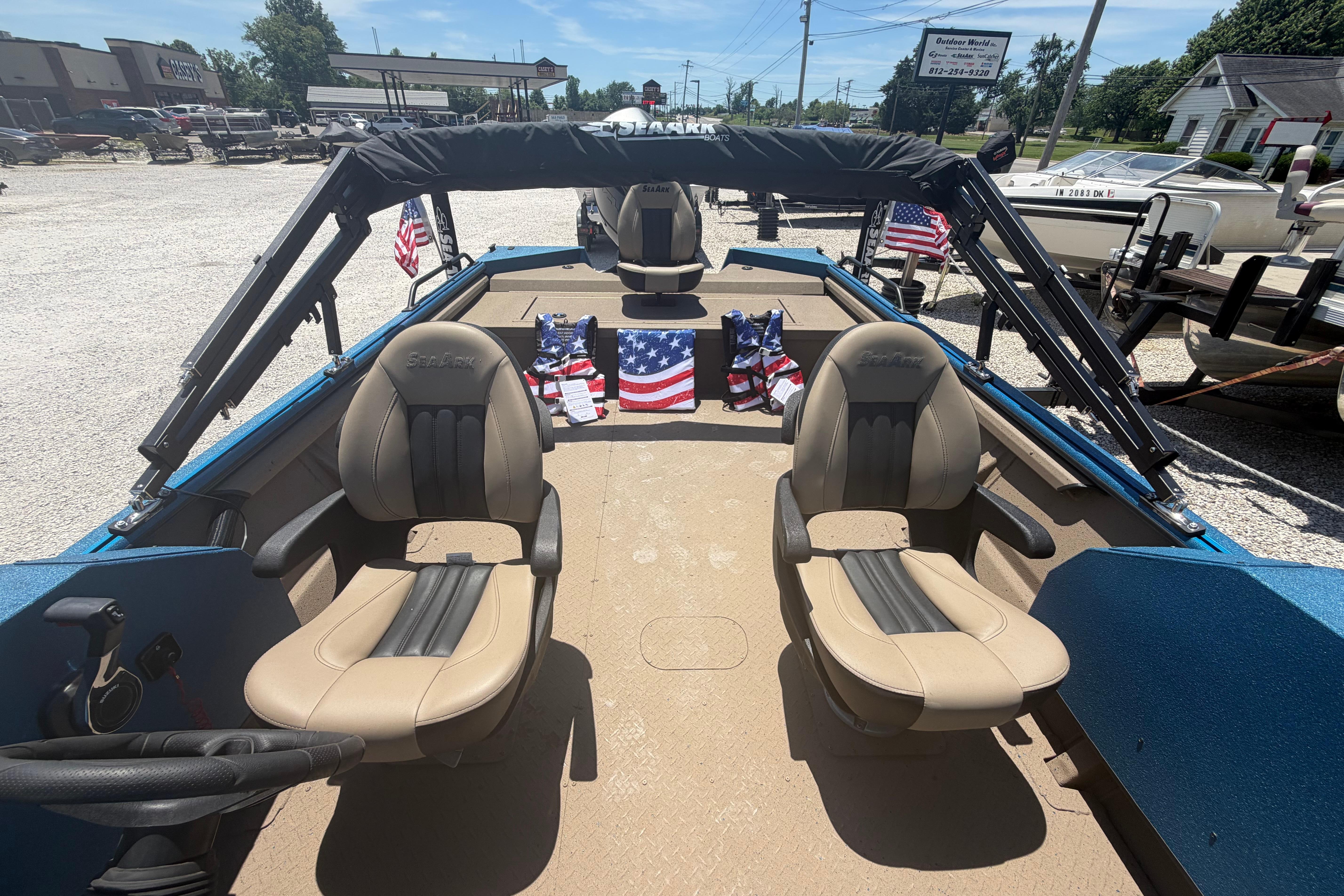 2025 SeaArk Protege 240 boat interior with beige seats and American flags.