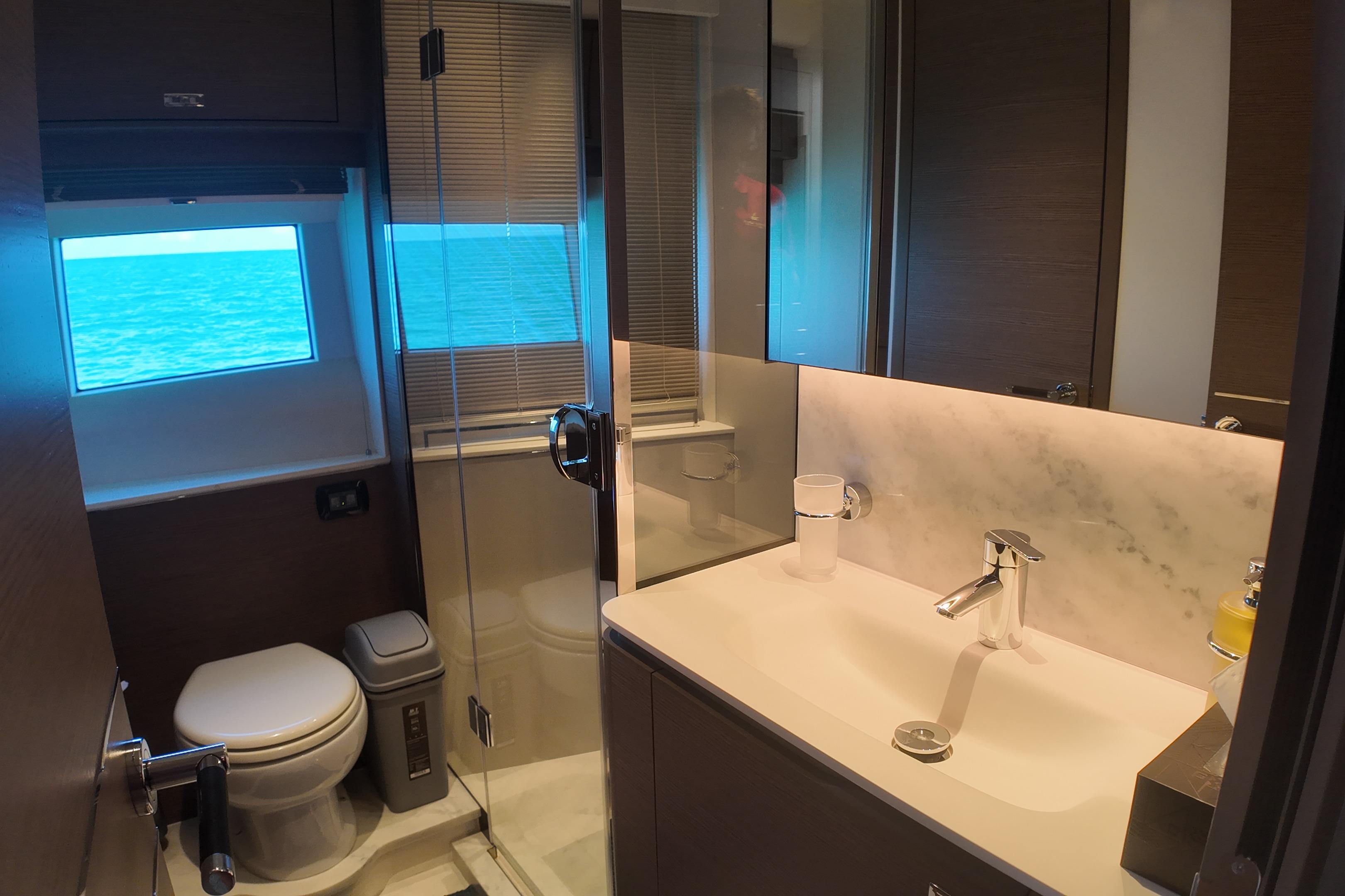 Luxurious bathroom on 2023 Princess Y72 yacht with ocean view window.