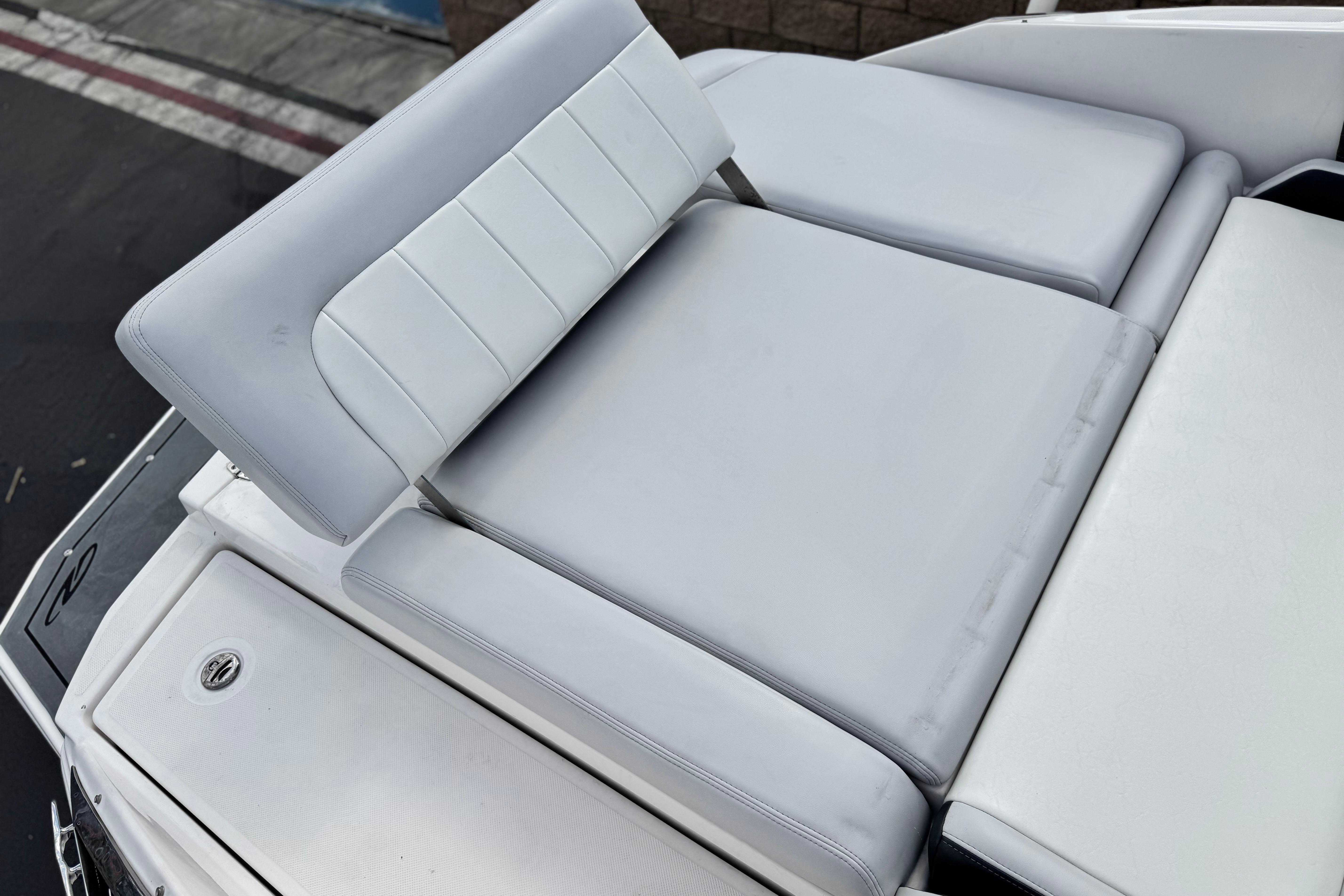 2014 Regal 27 FasDeck boat with white cushioned seating area.
