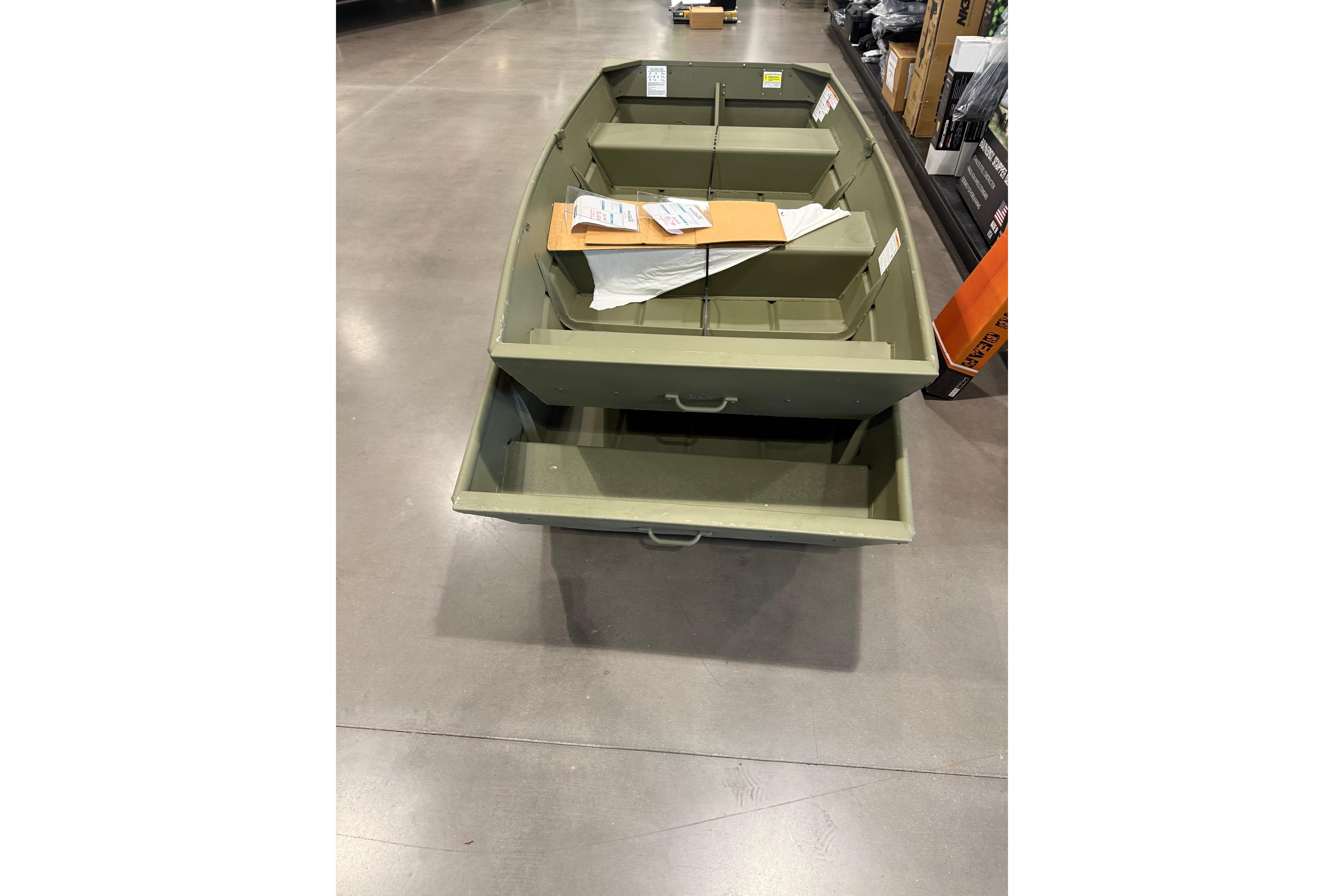 2025 Crestliner 1040 CR Jon boat displayed in a store, showcasing its sturdy design.