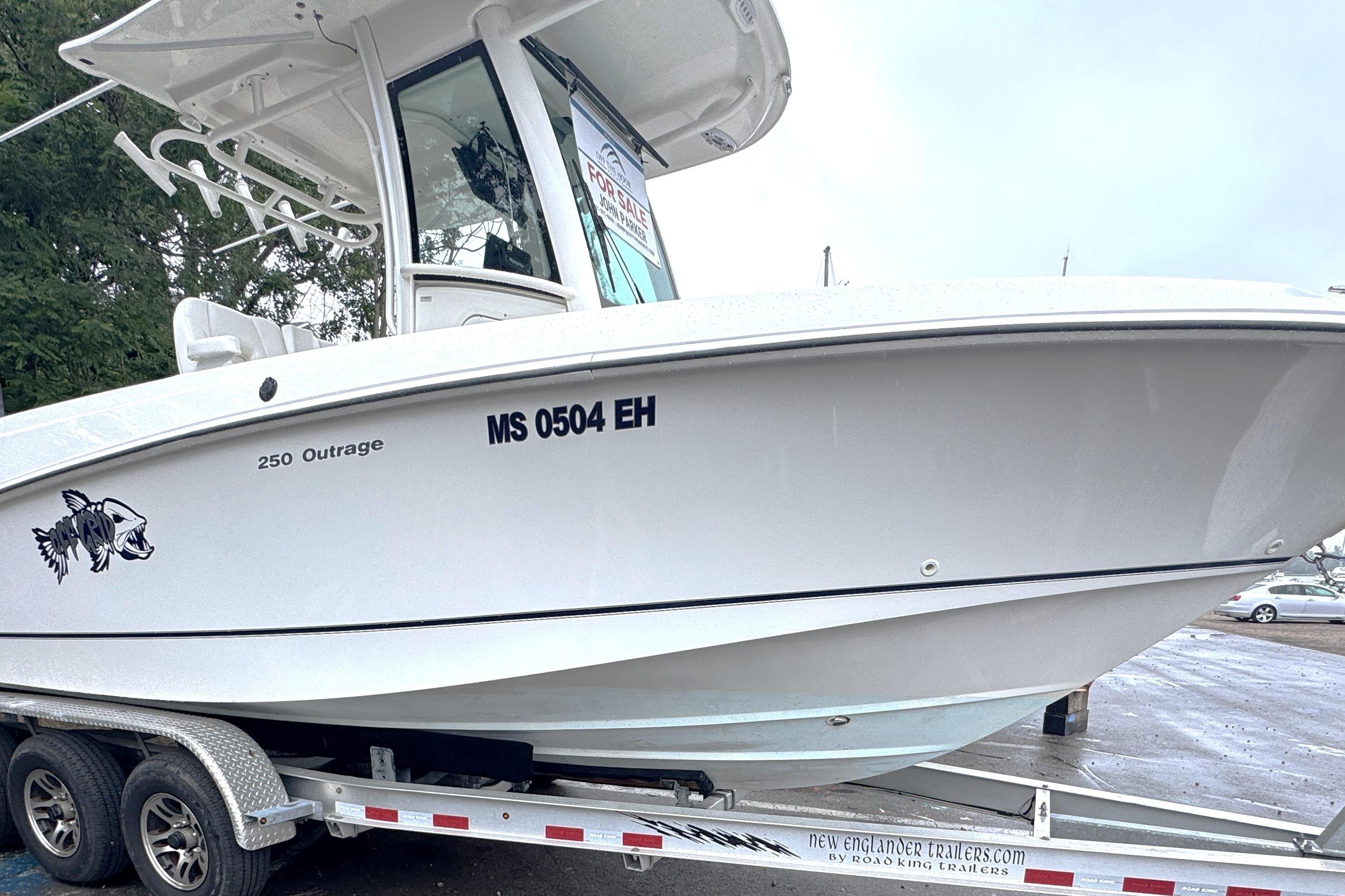 2014 Boston Whaler 250 Outrage boat on trailer, side view, with registration number visible.
