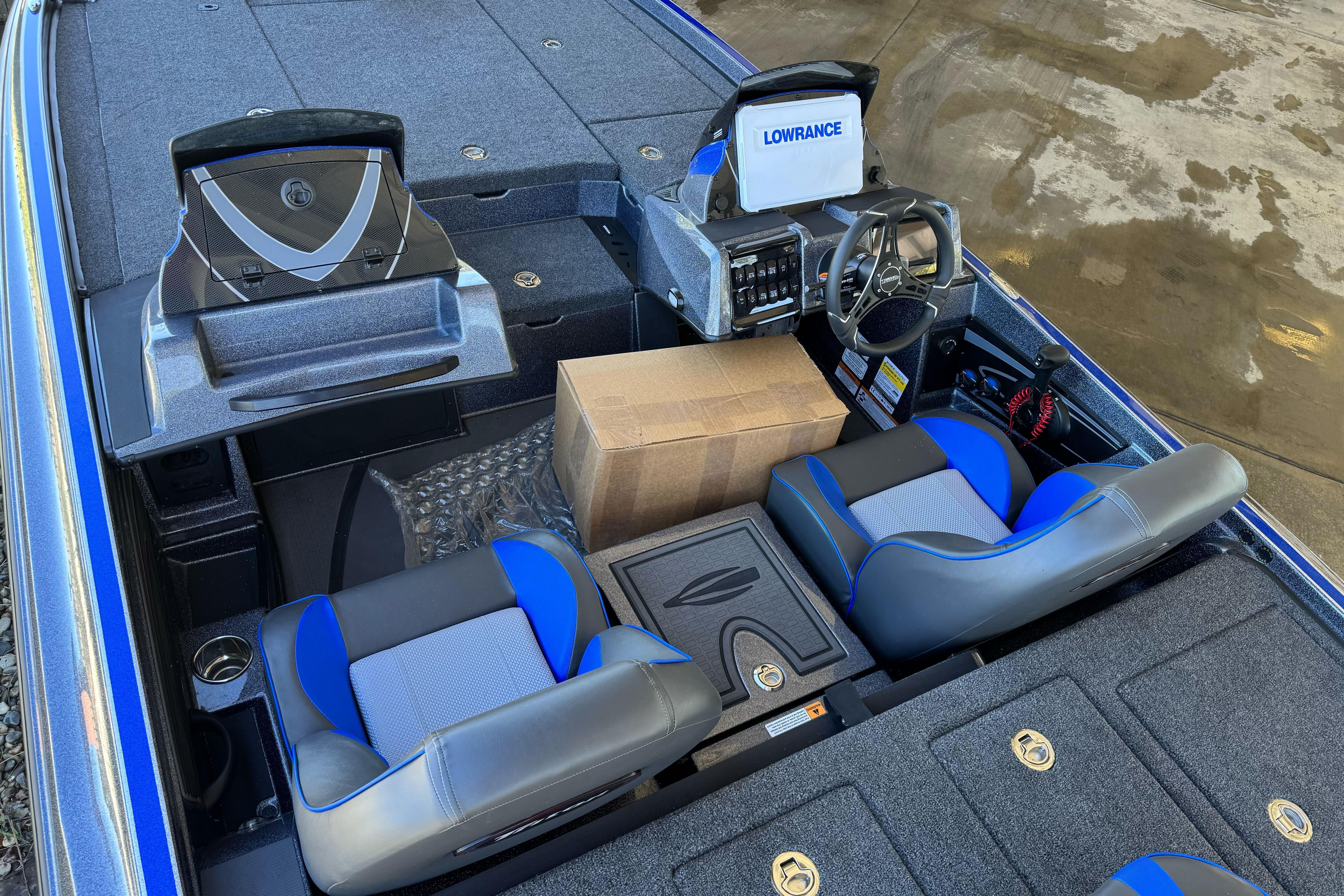 2026 Triton 21XP Patriot boat interior with blue seats and navigation equipment.