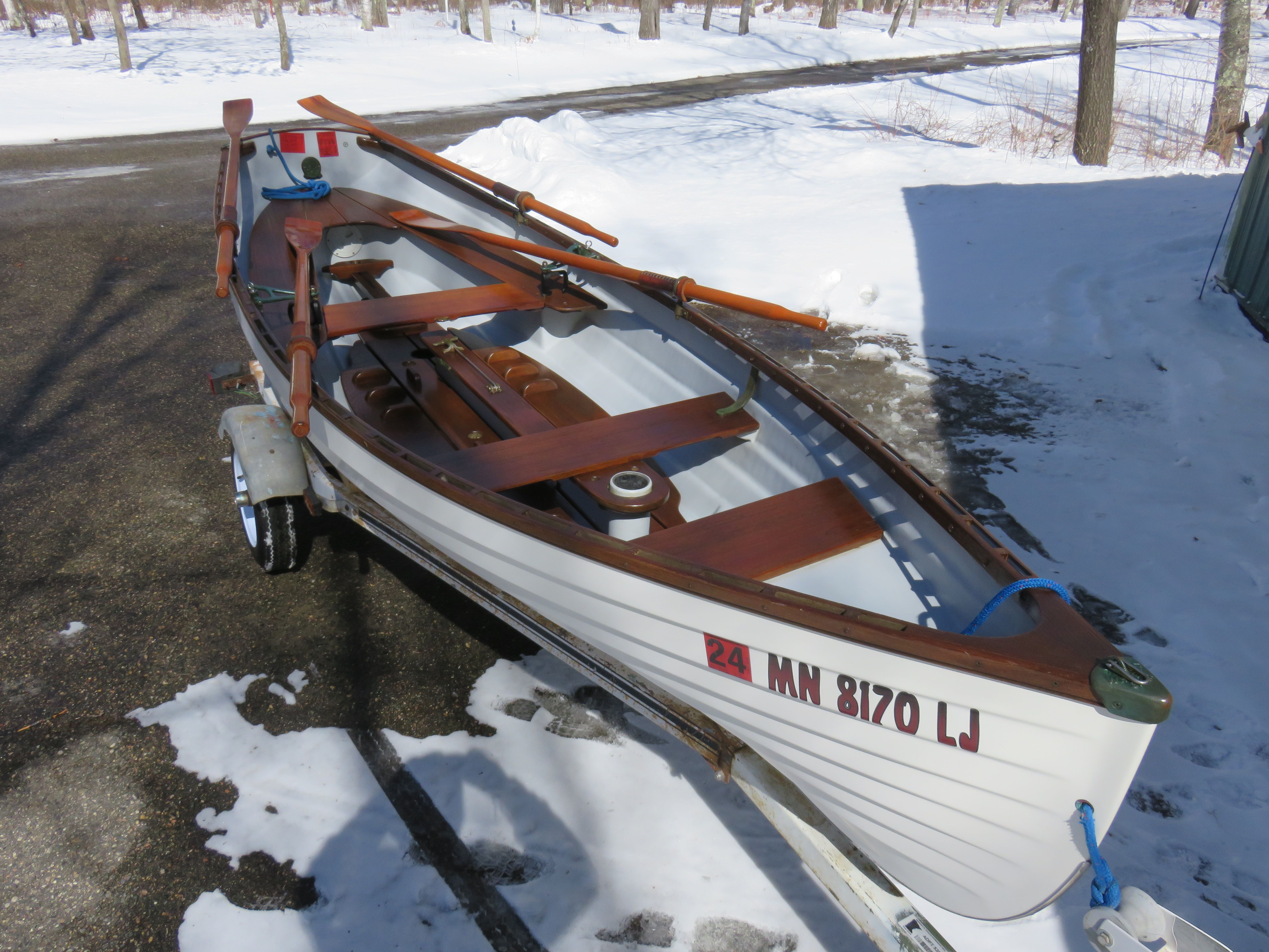 A 2005 Whitehall Spirit 14 rowing boat on a trailer in the snow.