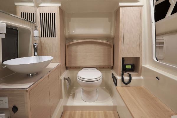 Manufacturer Provided Image: 2017 Chris-Craft Catalina 34 bathroom with modern fixtures and wooden cabinetry.